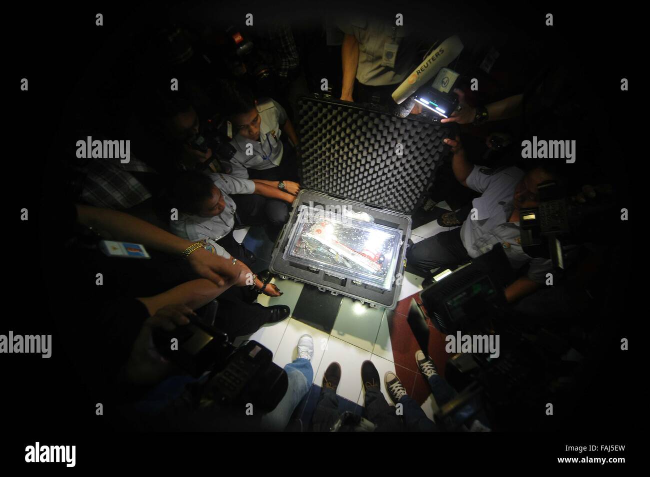 Beijing, Indonesia. 12th Jan, 2015. Indonesia's National Transportation Safety Committee (KNKT) members open the hardcase of Flight Data Recorder (FDR) of AirAsia Flight QZ8501 in Jakarta, Indonesia, Jan. 12, 2015. © Agung Kuncahya B./Xinhua/Alamy Live News Stock Photo
