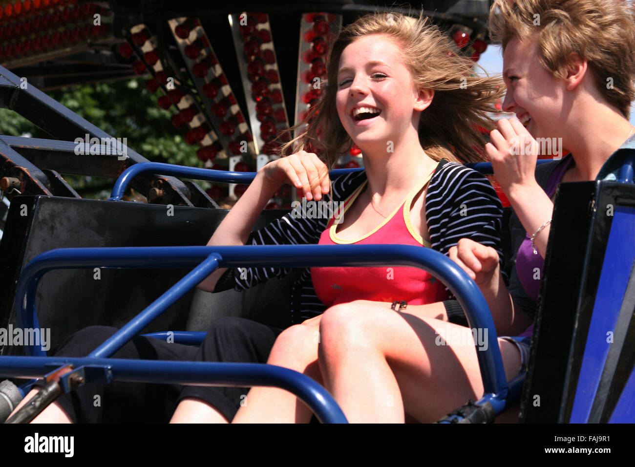 Girls enjoying fairground ride. Stock Photo