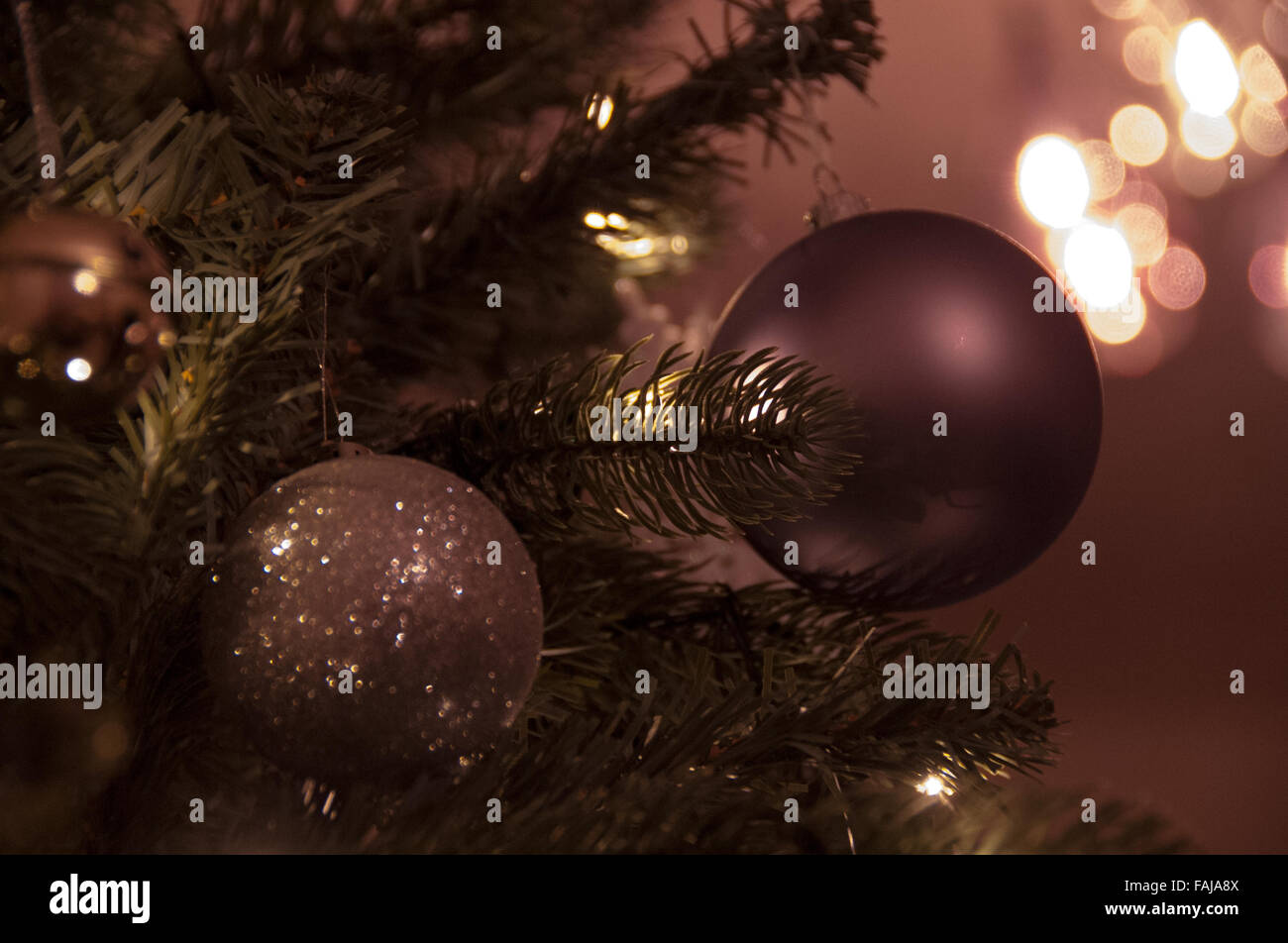 Christmas decorations on a tree with lights Stock Photo