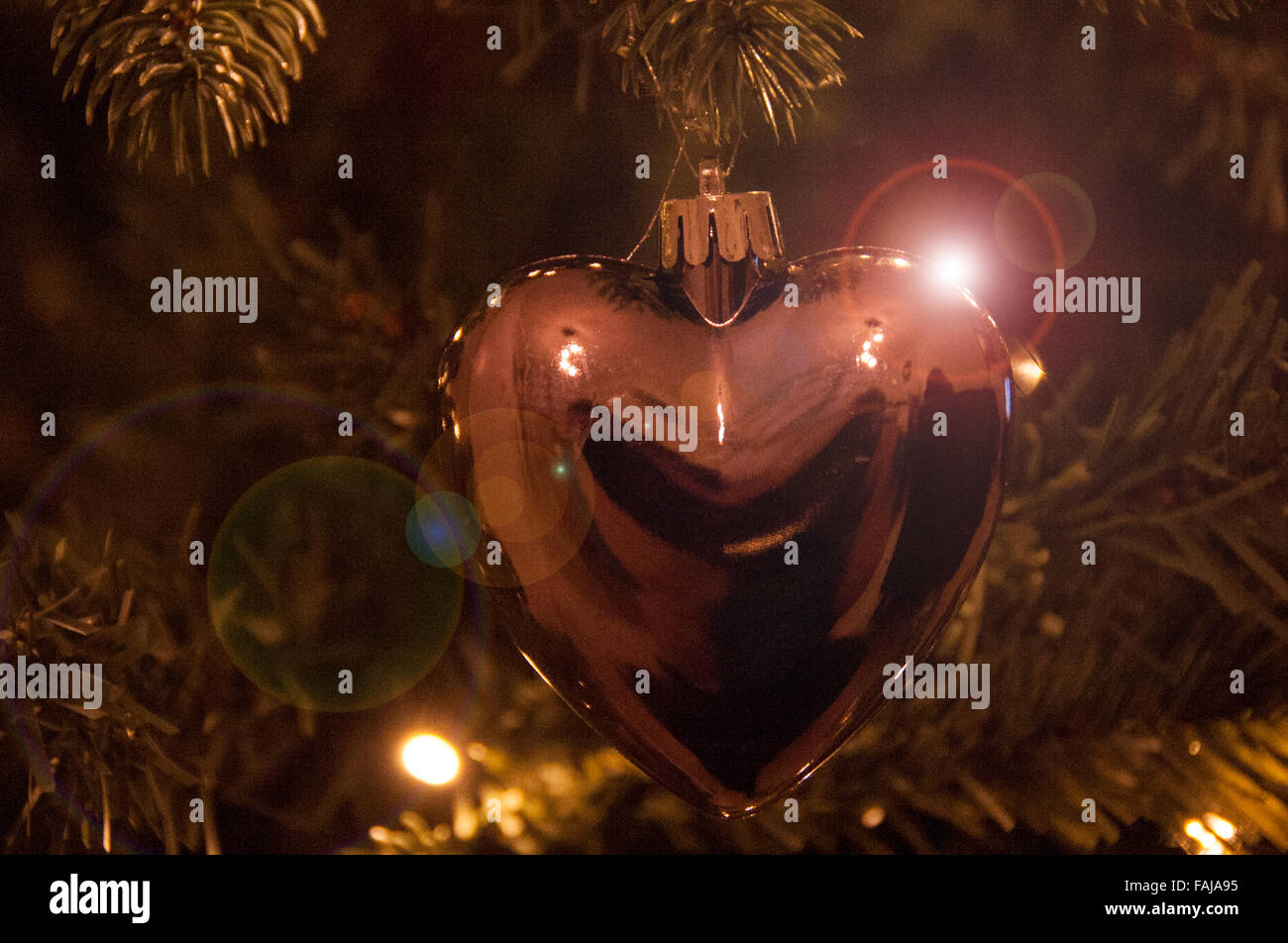 Christmas decorations on a tree with lights Stock Photo