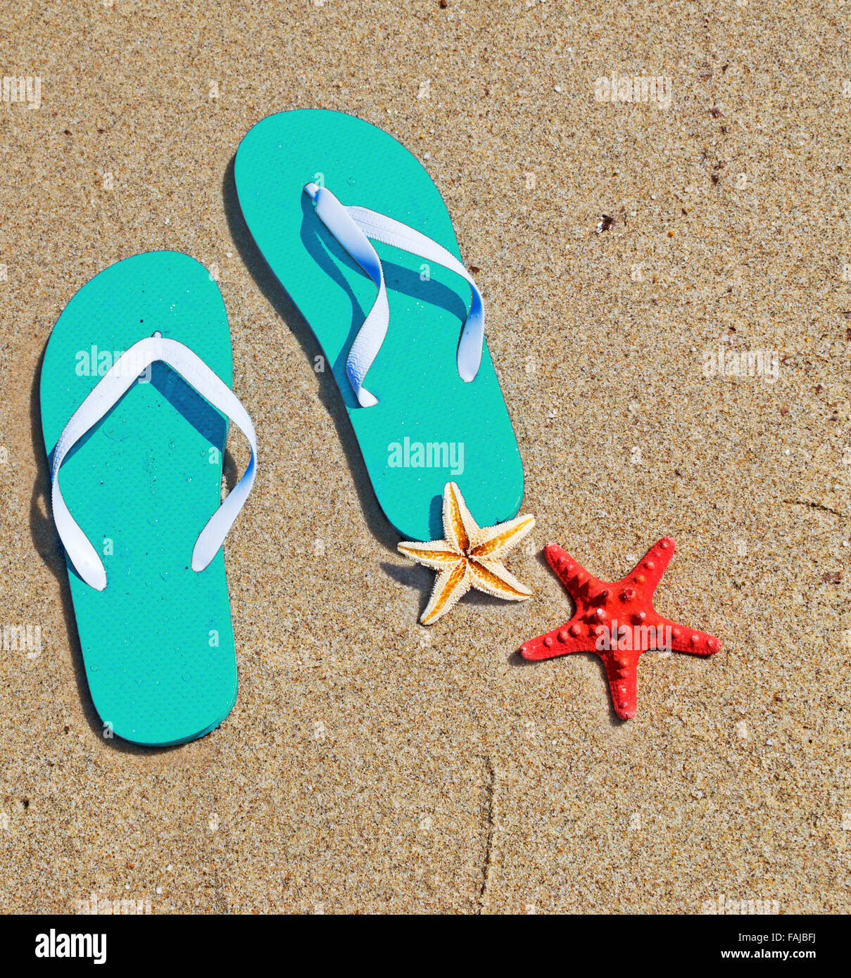 flip flops on the sand in a tropical beach Stock Photo - Alamy