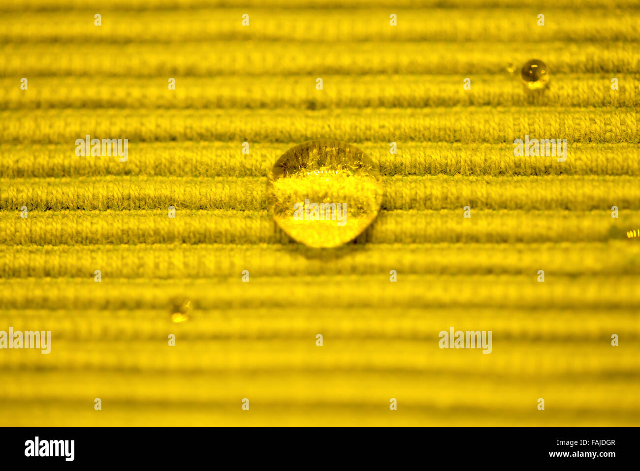 Macro Water Drop on a yellow cloth Stock Photo - Alamy