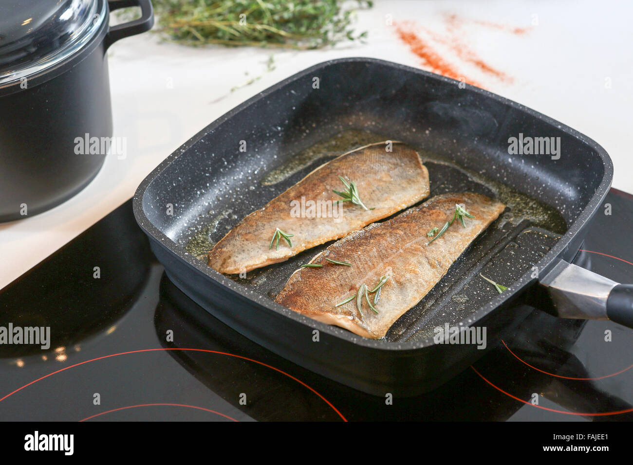 Frying fish on an electric stove Stock Photo Alamy