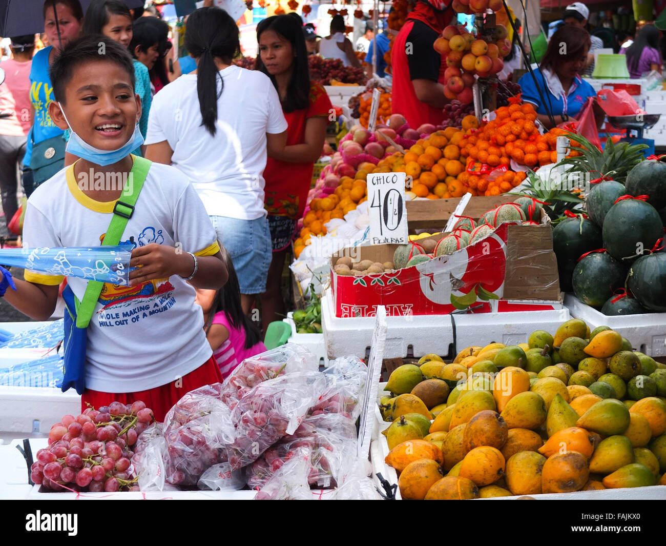 A young male fruit vendor gleefully peddling his merchandise to the public at Divisoria, Manila Filipinos anticipation of the last celebration on the calendar, The New Year's Eve with much merry making and superstitious belief on rounded fruits, It believes that it could bring luck. (Photo by Josefiel Rivera / Pacific Press) Stock Photo