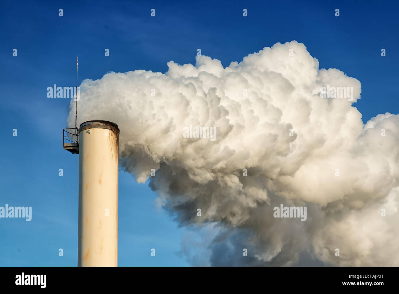 factory chimney and smokestack on blue sky background Stock Photo