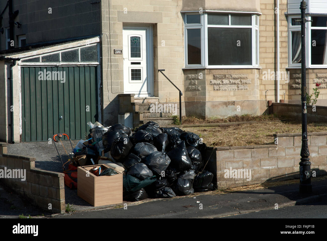 A pile of black bin backs on the street as students moving out of house share, Southdown, Bath, Somerset, UK Stock Photo