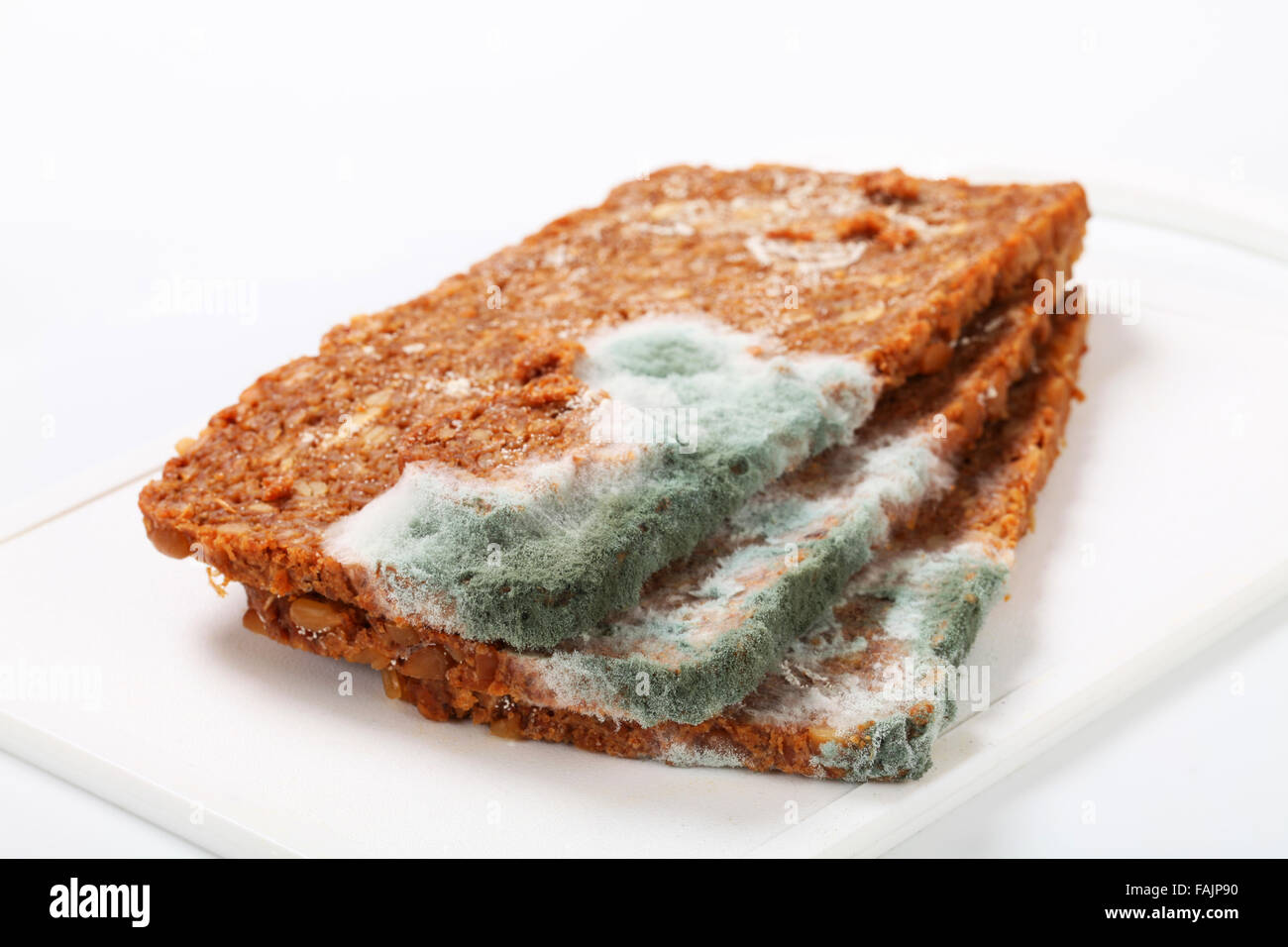 Slices of brown bread covered with mold Stock Photo