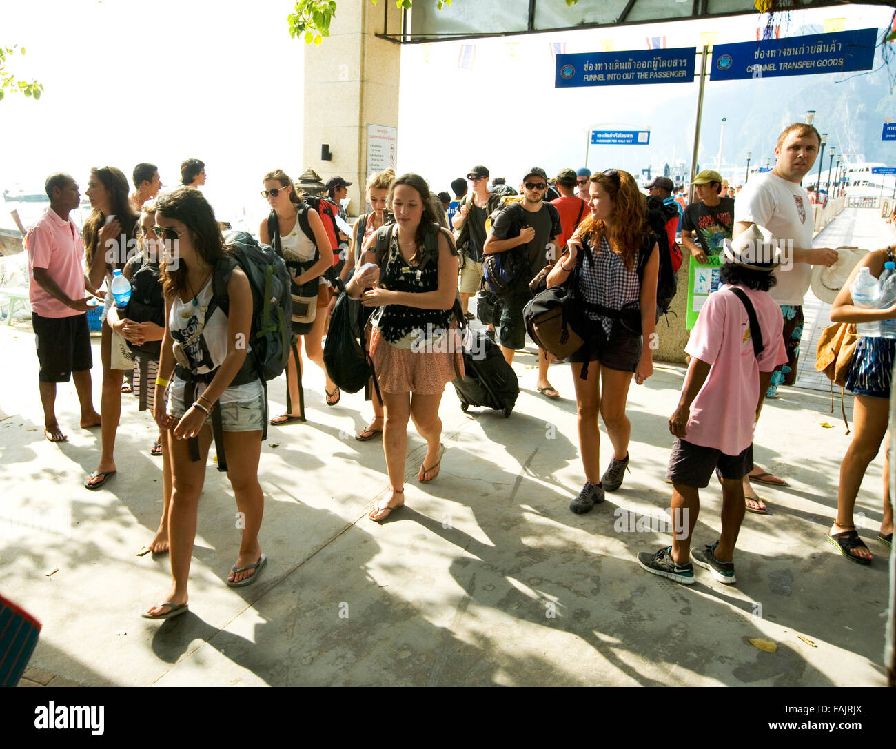 Backpackers arriving at a port in Thailand. Stock Photo