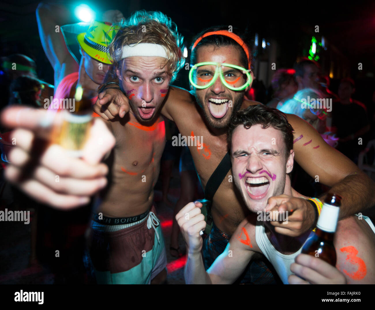 Three Men Dressed Up Enjoying a Party. Stock Photo