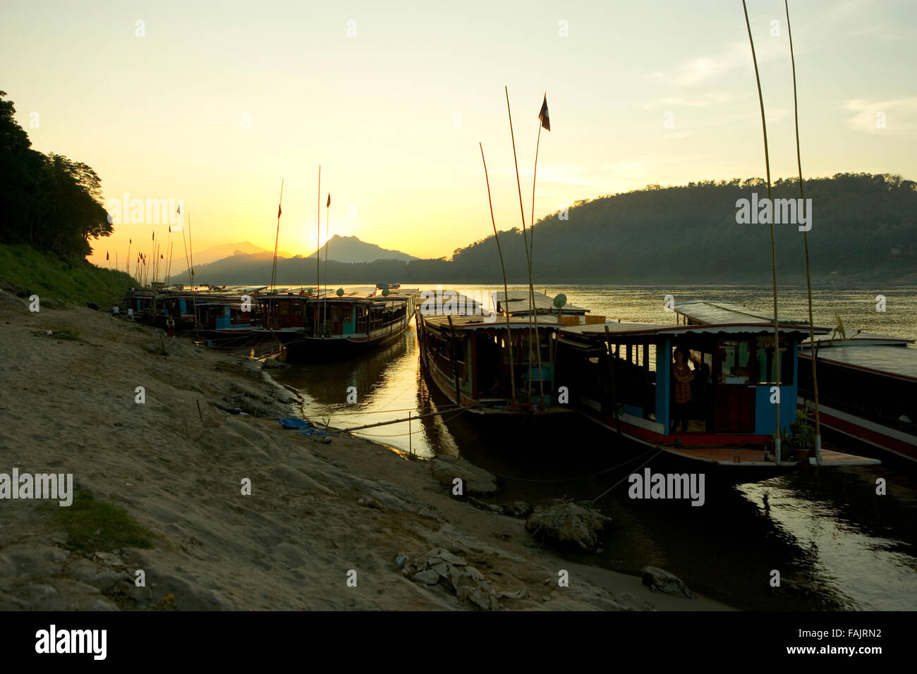Boats on the Mekong River, Pak Beng, Laos. At sunset, dawn, morning, evening, South East Asia. Stock Photo