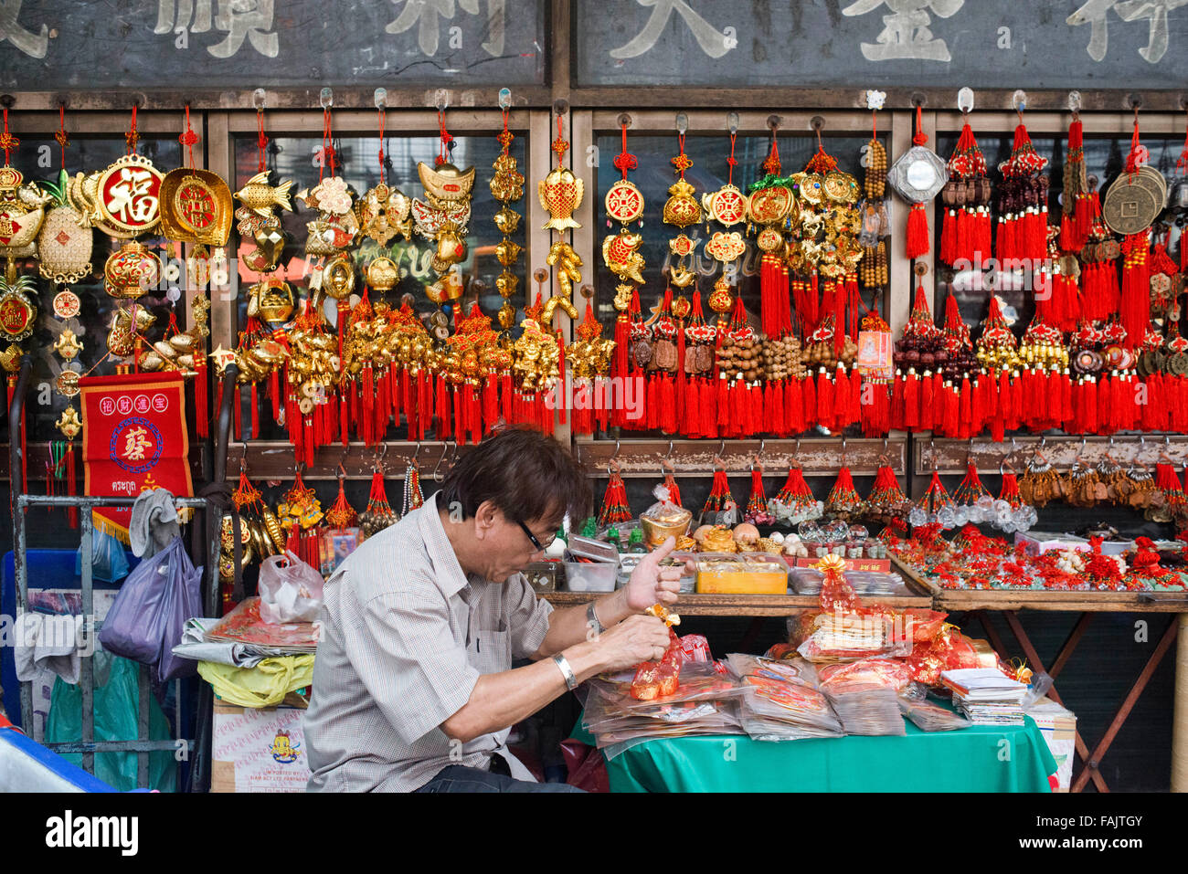 Amulets stall in the street in Chinatown Bangkok, Thailand. Yaowarat, Bangkok’s Chinatown, is the World’s most renowned street food destination and the local favorite dining district. Stock Photo