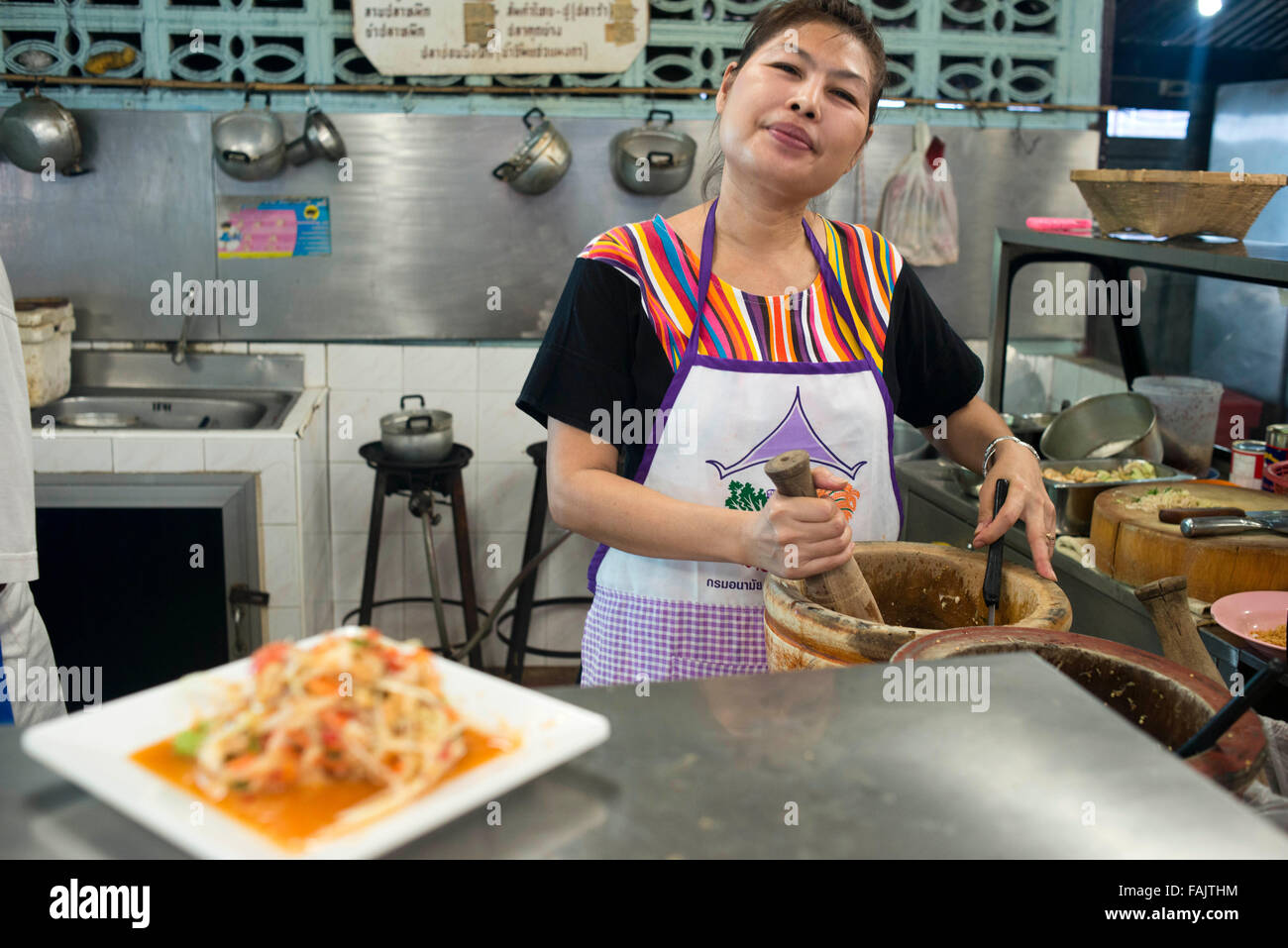 Yum Rod Sab restaurant. Preparing a typical green papaya salad in the