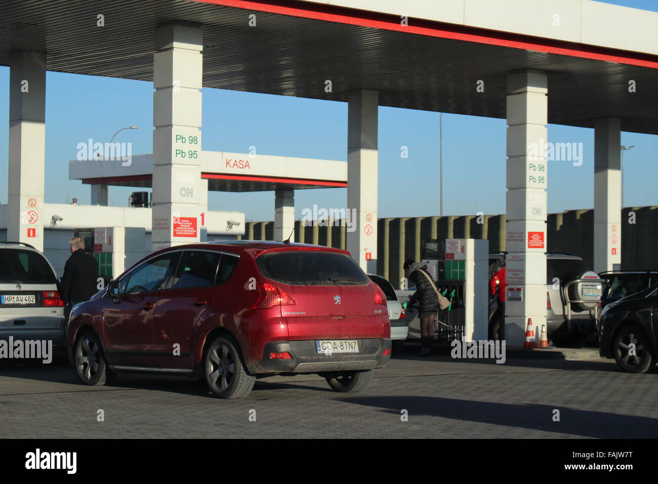 Gdansk, Poland 31st, Dec. 2015 Cars wait in line to refueling at AUCHAN gas  station in Gdansk. At many gas stations in Gdansk price of E95 gasoline and  Diesel fuel is lower