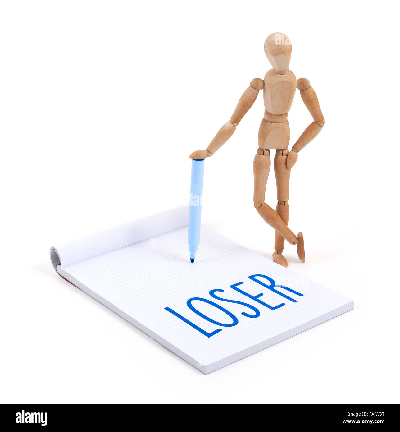 Wooden mannequin writing in a scrapbook - Loser Stock Photo