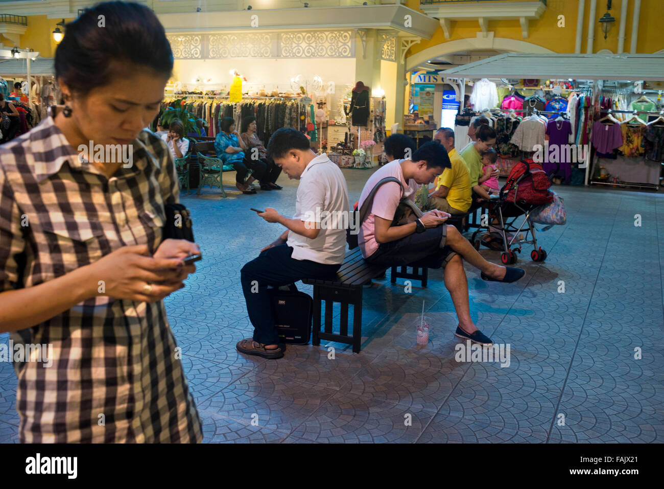 Everyone is connected to the mobile phone, Bangkok mall, Thailand. Stock Photo