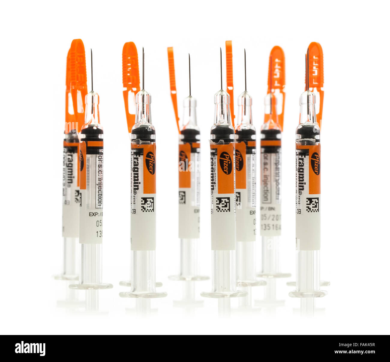 Collection of Single Dose Syringes from Pfizer on a White Background Stock Photo