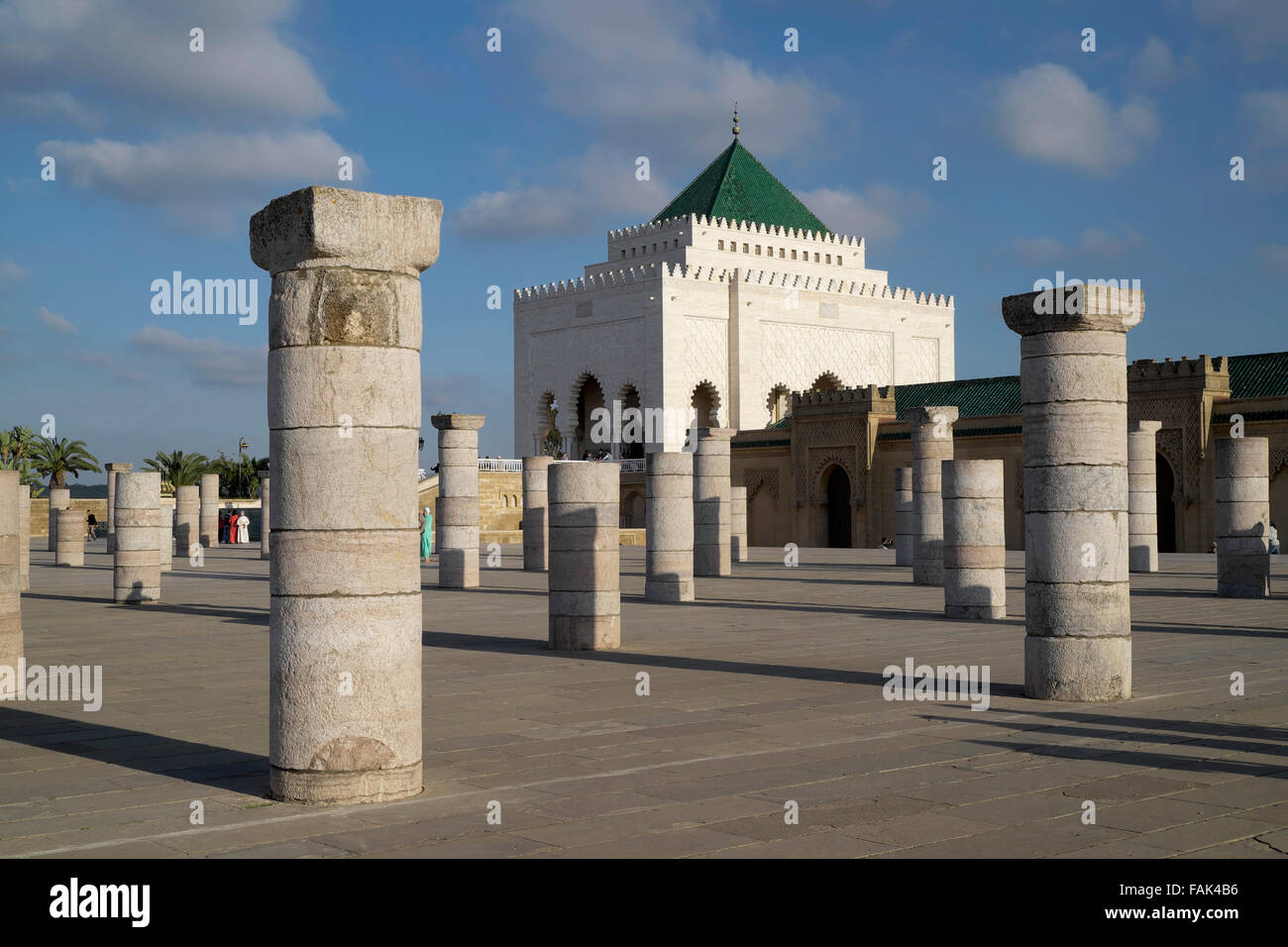 Remains of columns of the former prayer hall of the Hassan Mosque, with the Mausoleum of Mohammed V, Rabat, Rabat province Stock Photo
