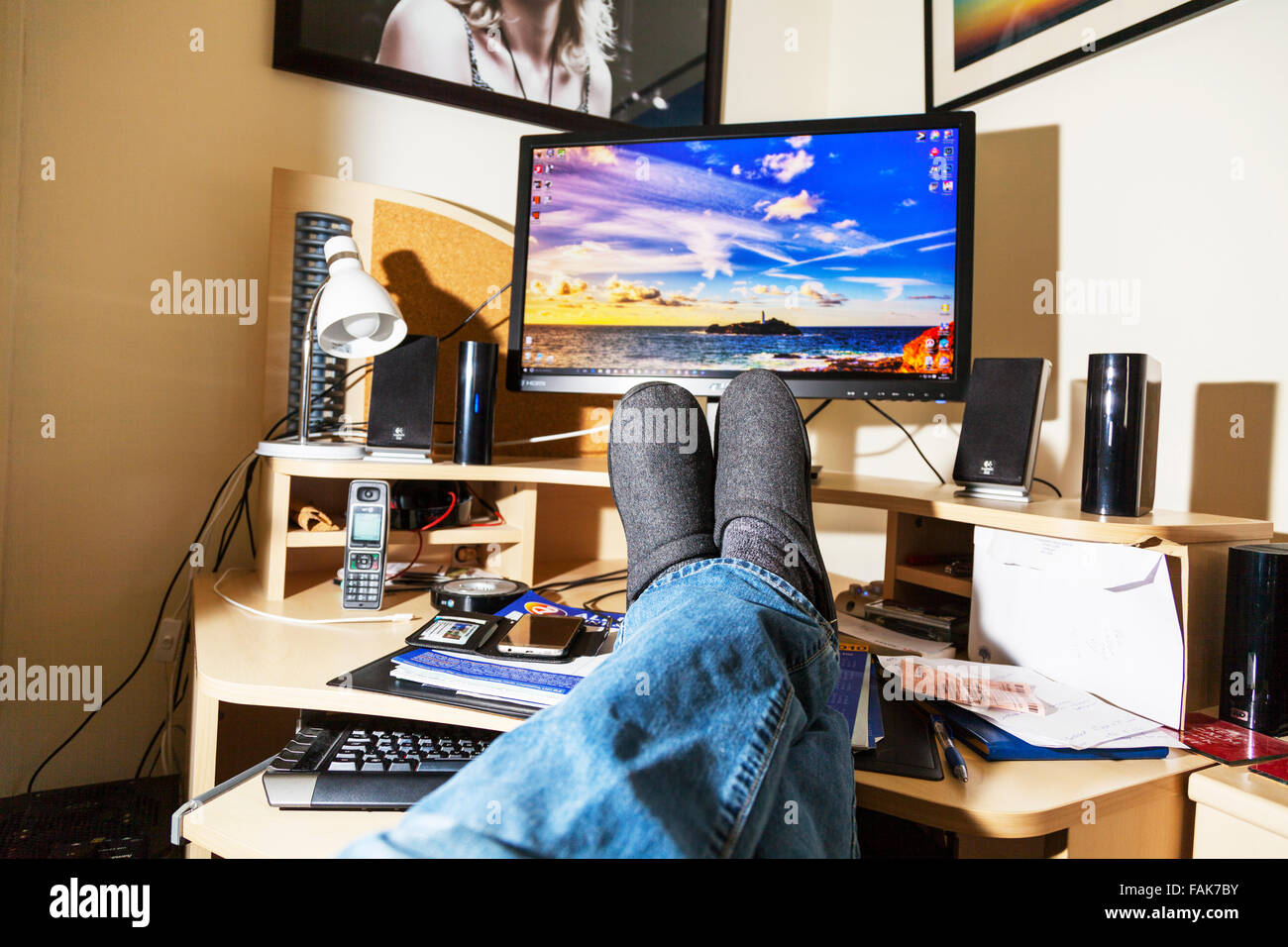 Feet on desk office worker relaxing in front of computer screen legs