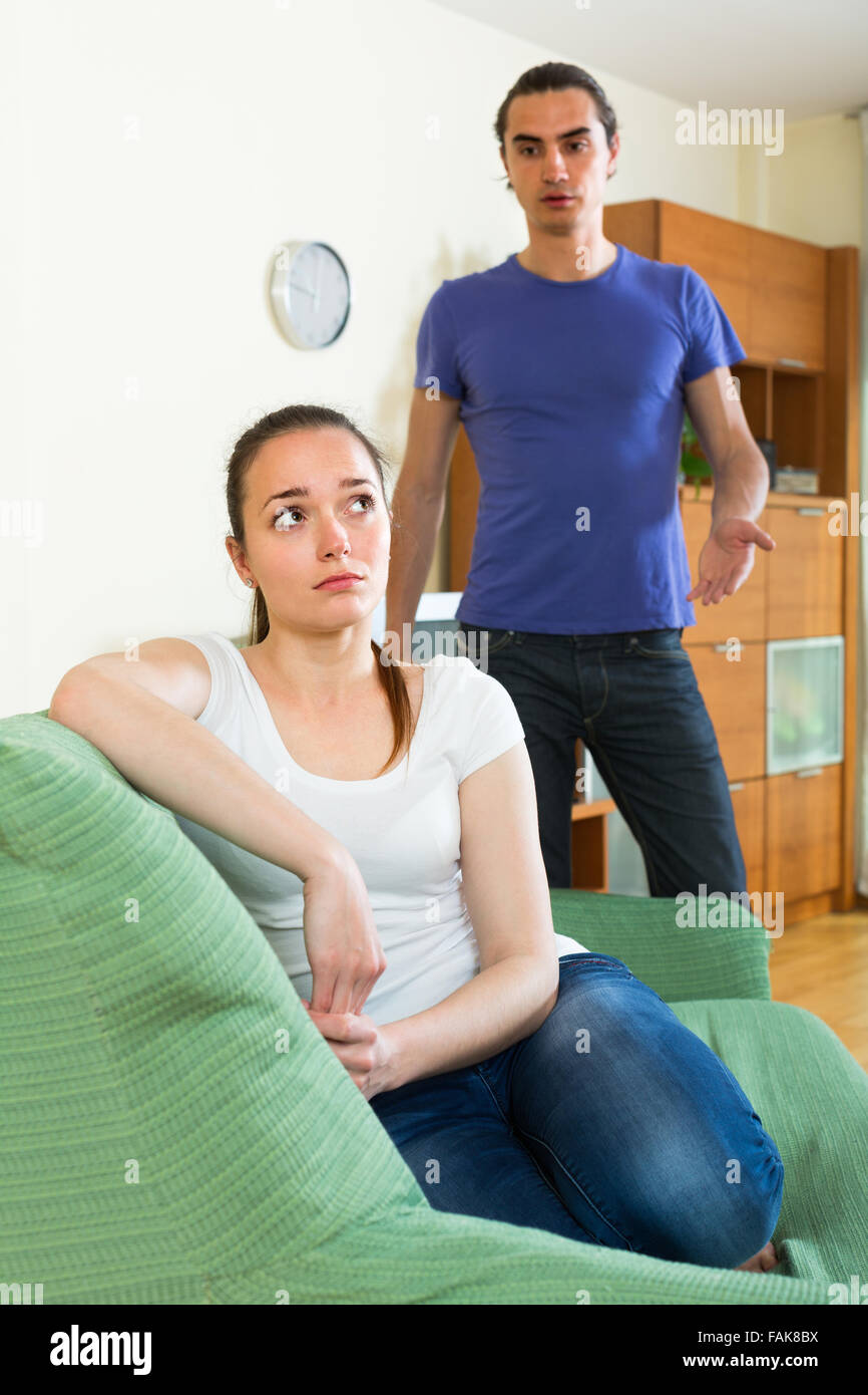 Sad young couple having conflict in the living room at home Stock Photo ...