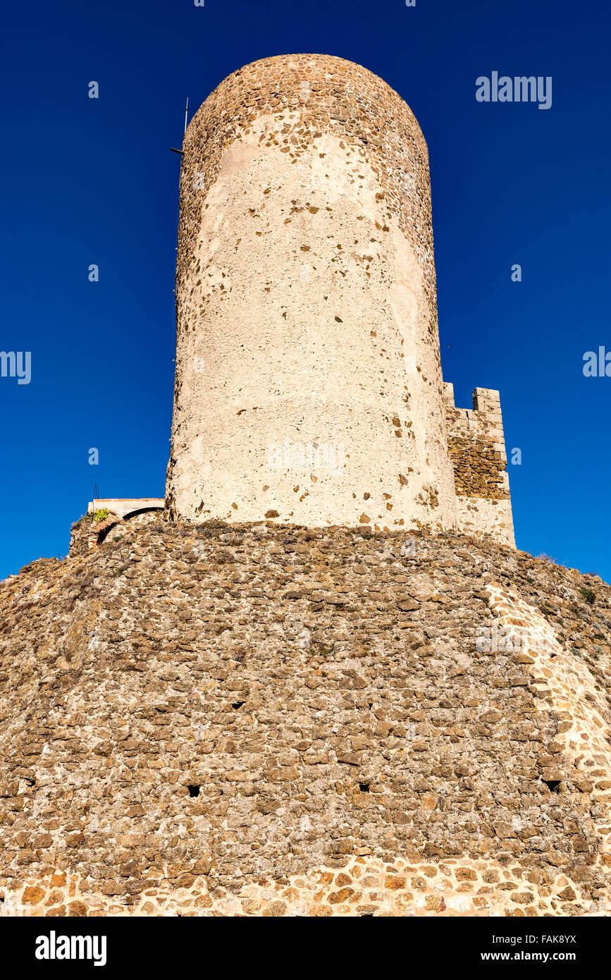 A tower of the Castell de Montsoriu stands against a blue sky. Stock Photo