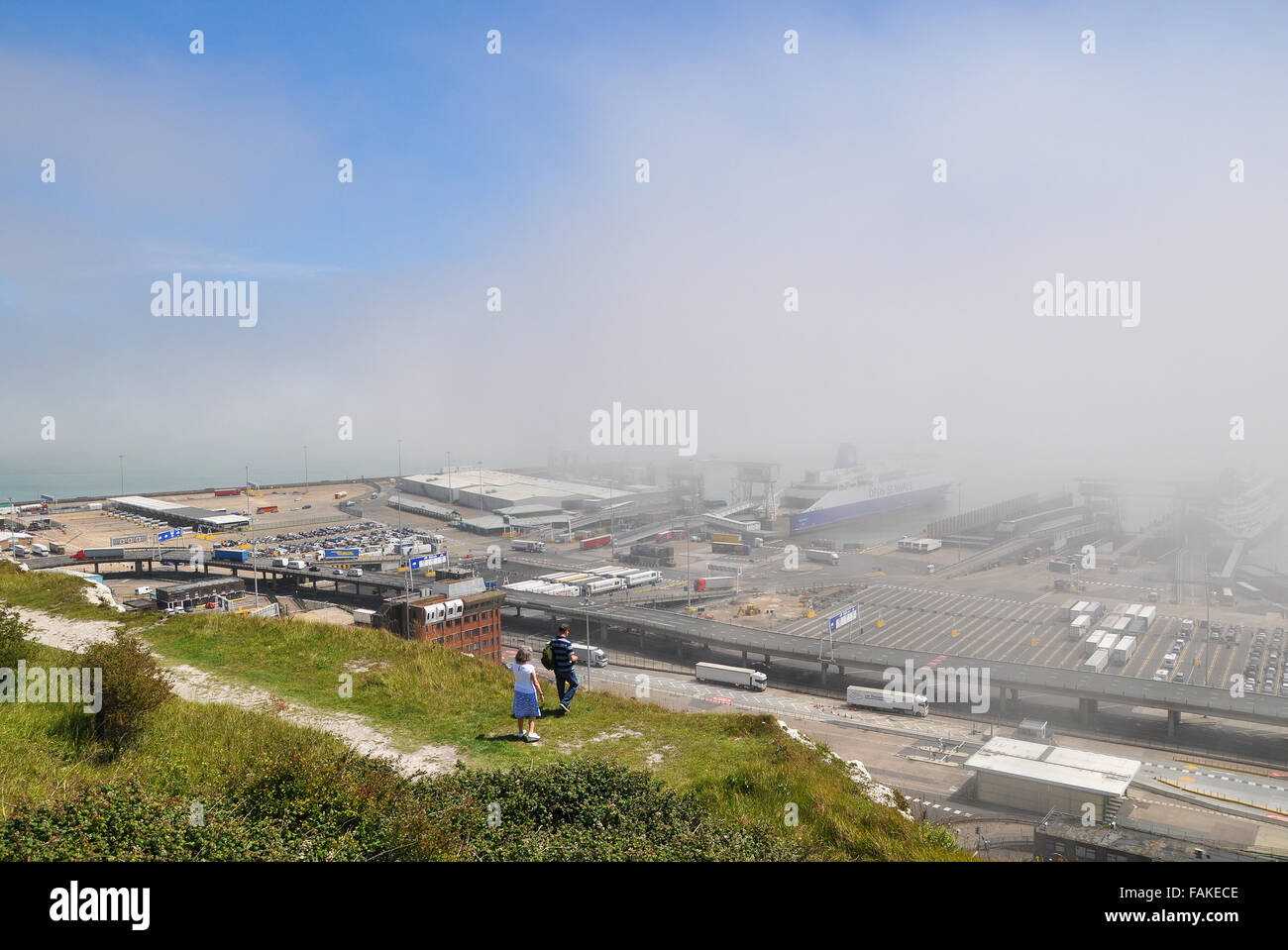 The Port of Dover is the cross-channel port situated in Dover, Kent, SE England. Here the port has a bank of sea mist or fog. Weather Stock Photo