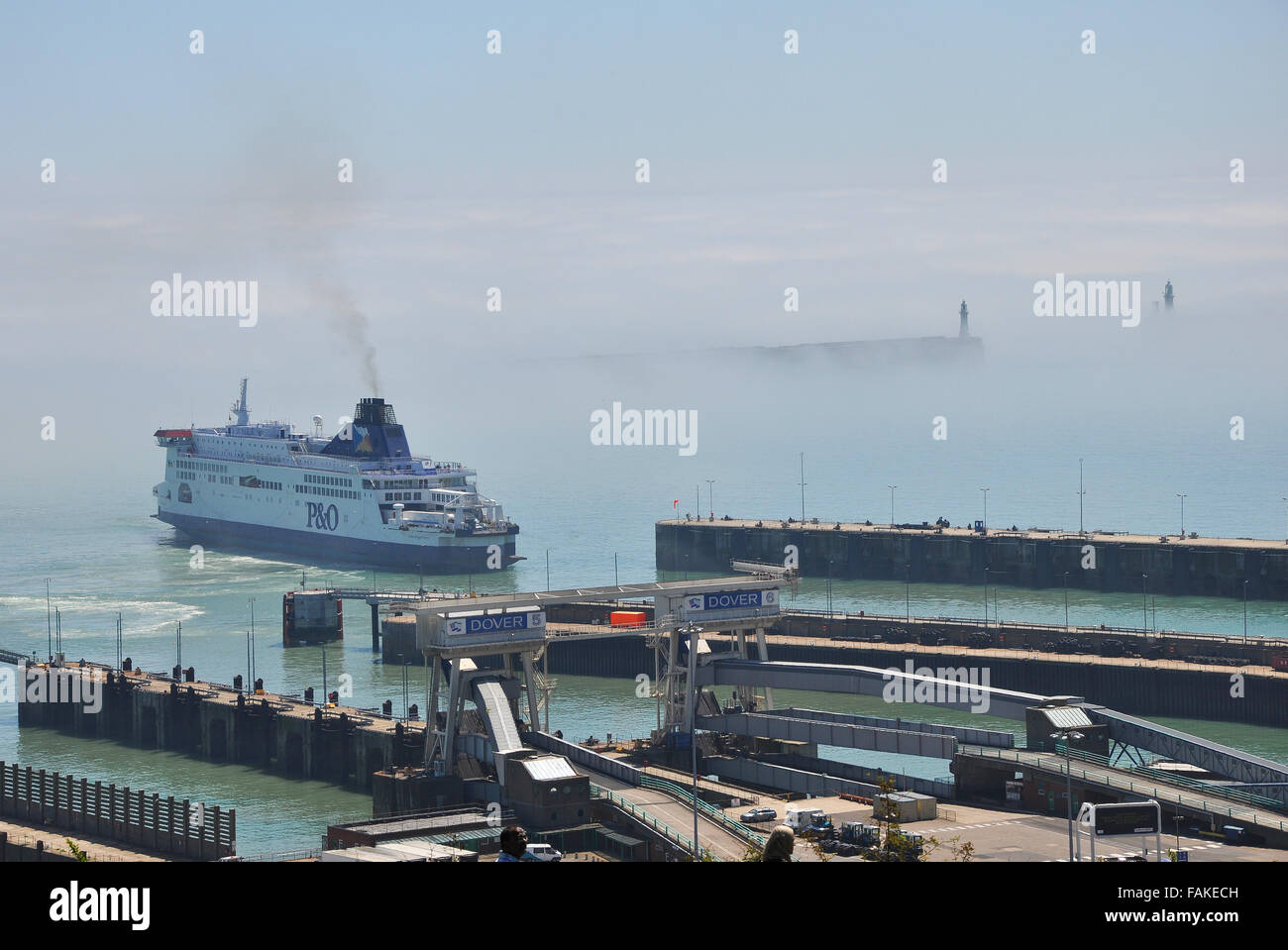 The Port of Dover is the cross-channel port situated in Dover, Kent, SE  England. Here the port has a bank of sea mist or fog. Weather. Space for  copy Stock Photo -