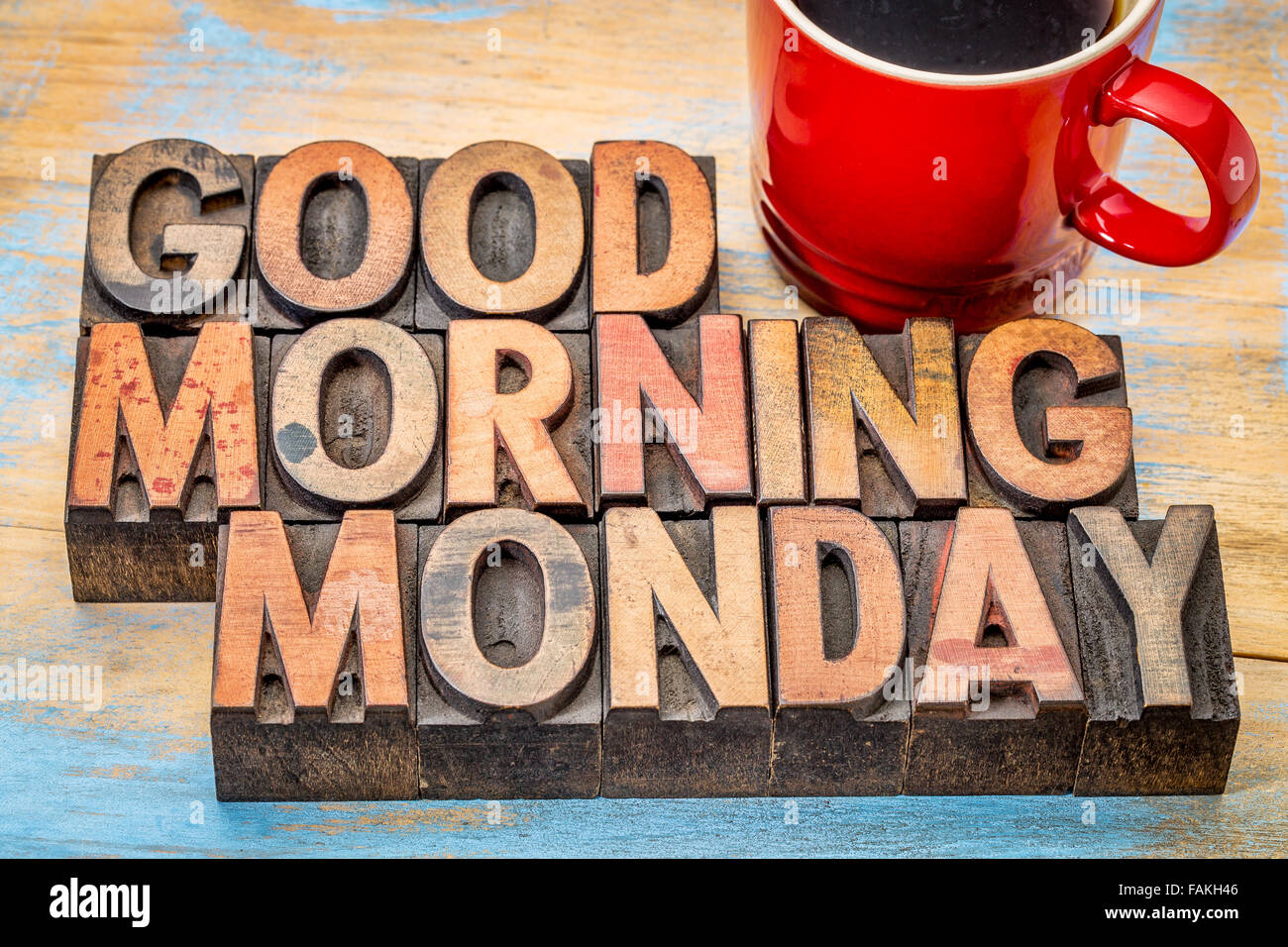 Good morning Monday in vintage letterpress wood type blocks with a cup of coffee Stock Photo