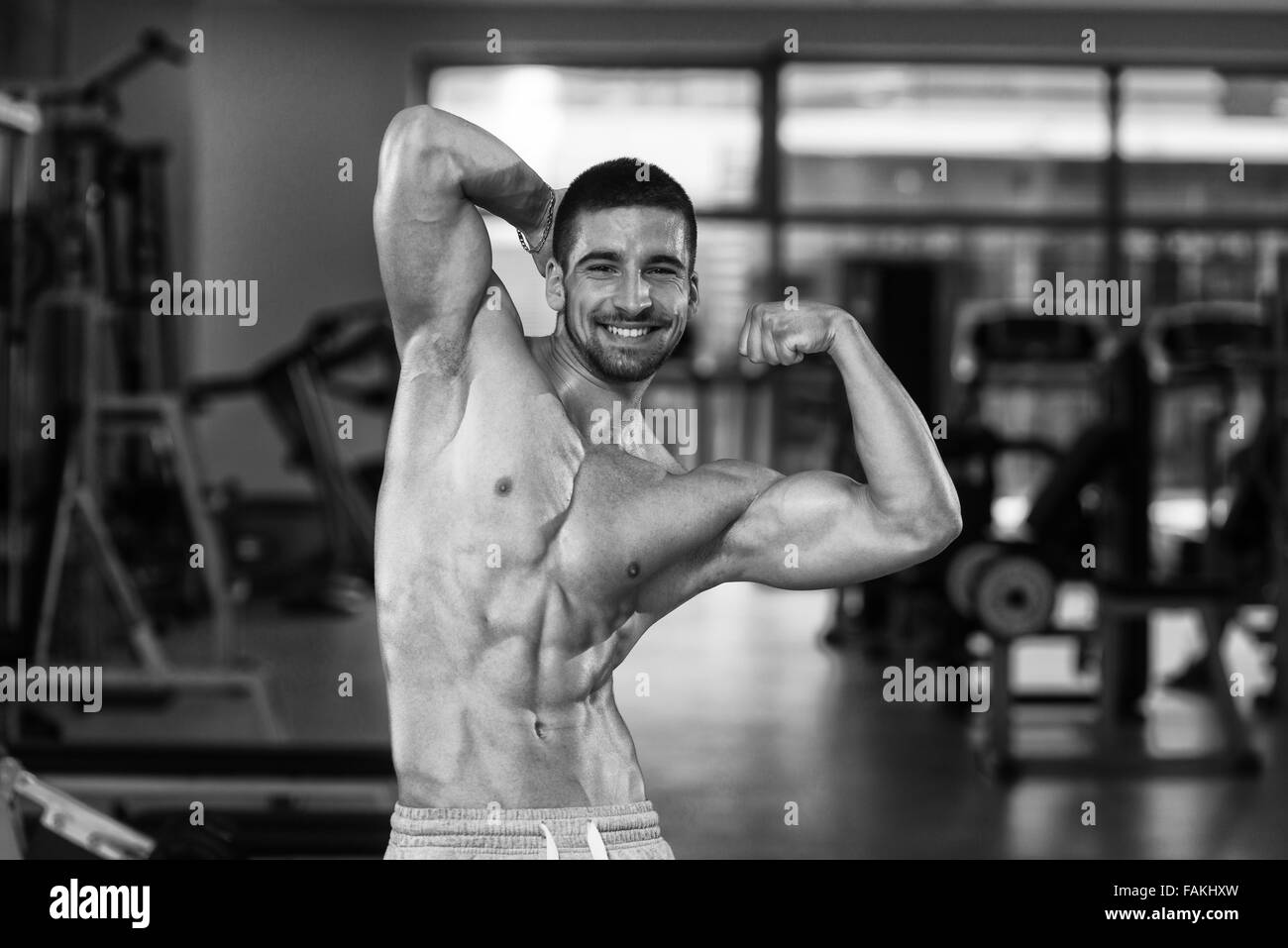 Young bodybuilder showing muscles Black and White Stock Photos & Images