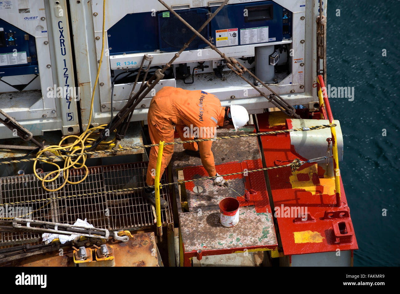 Container ship crew member works on the deck of Utrillo cargo vessel Stock Photo