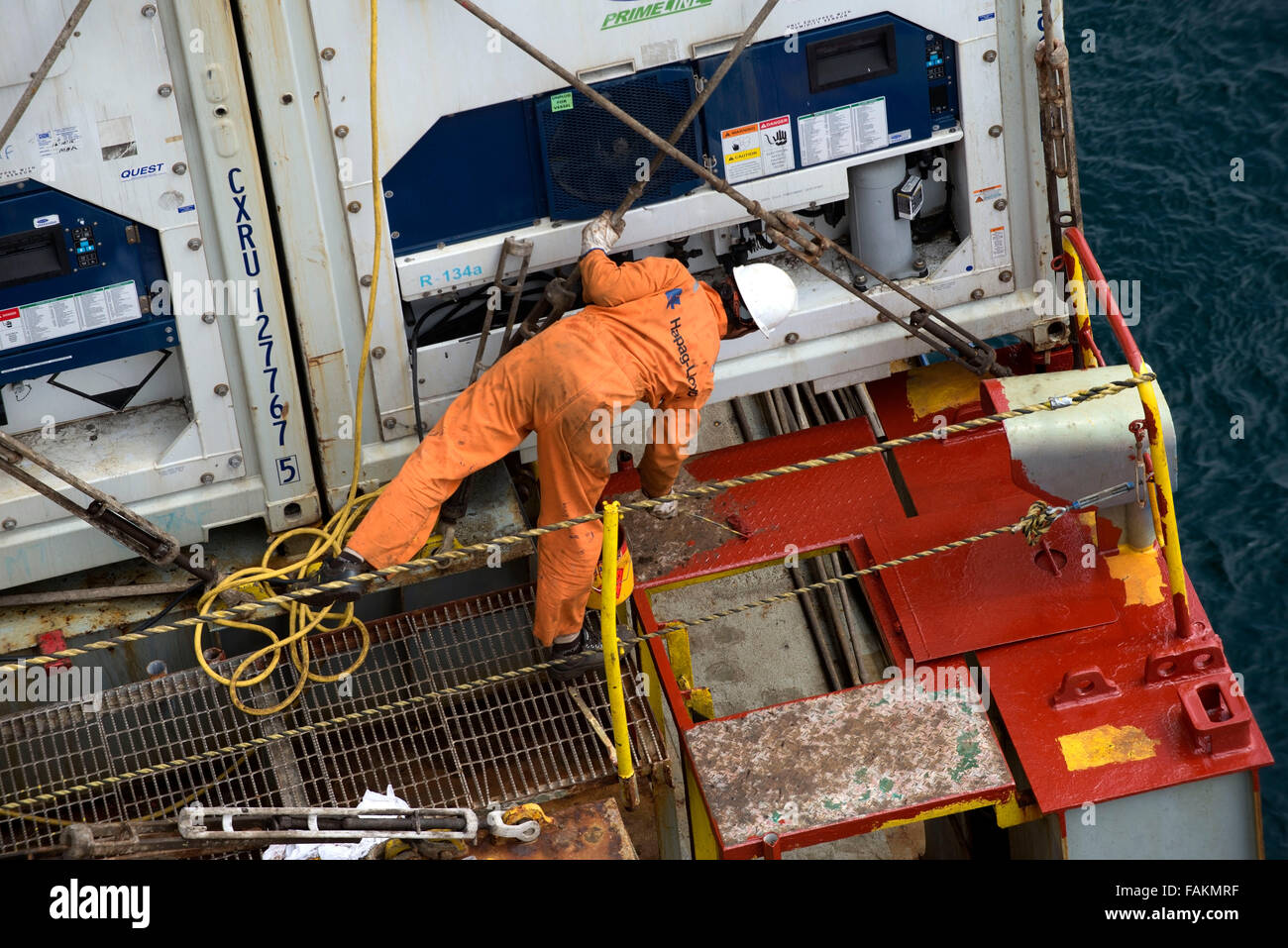 Container ship crew member works on the deck of Utrillo cargo vessel Stock Photo