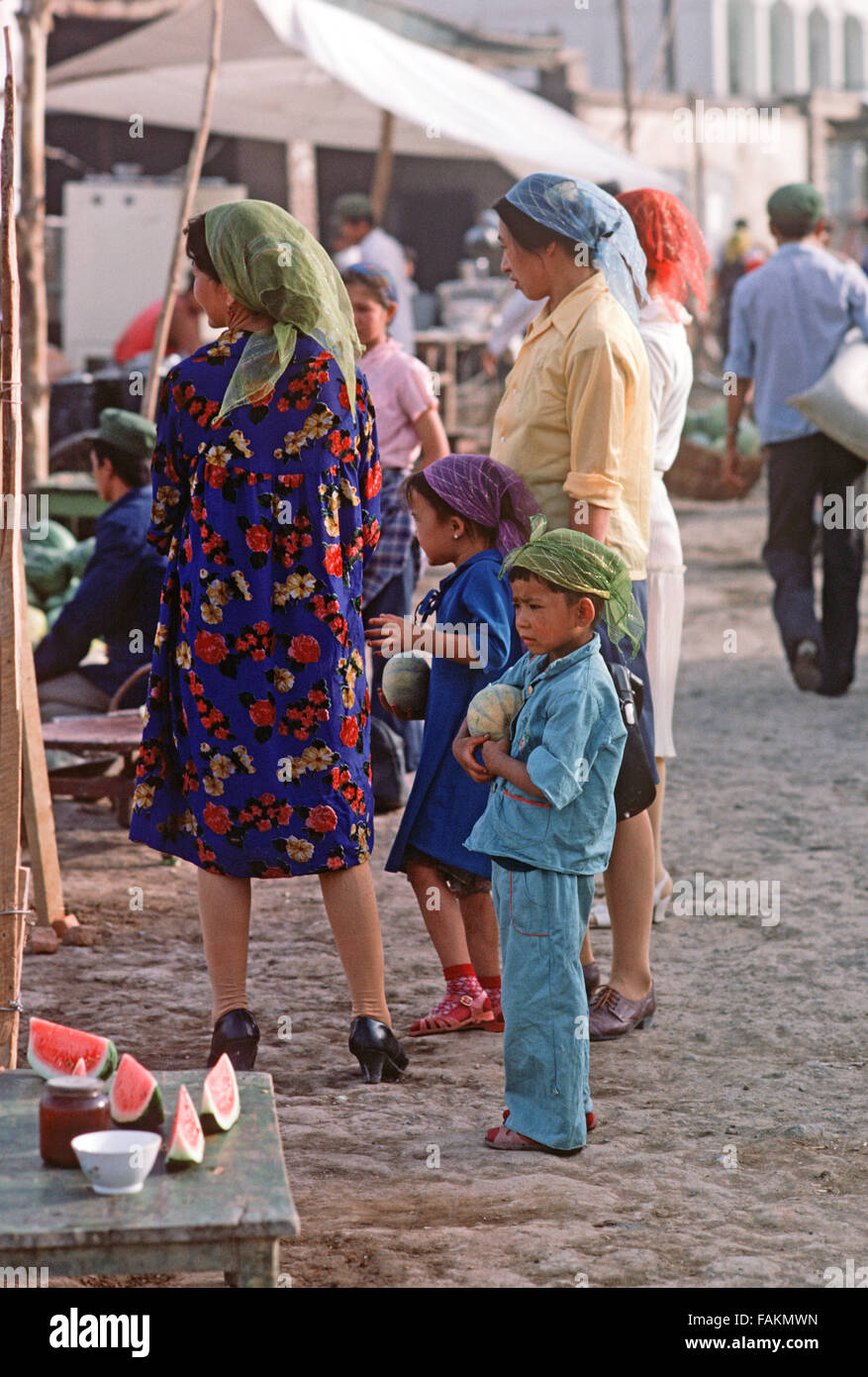 Uyghur women and children in Turpan market, Xinjiang Province, China Stock Photo