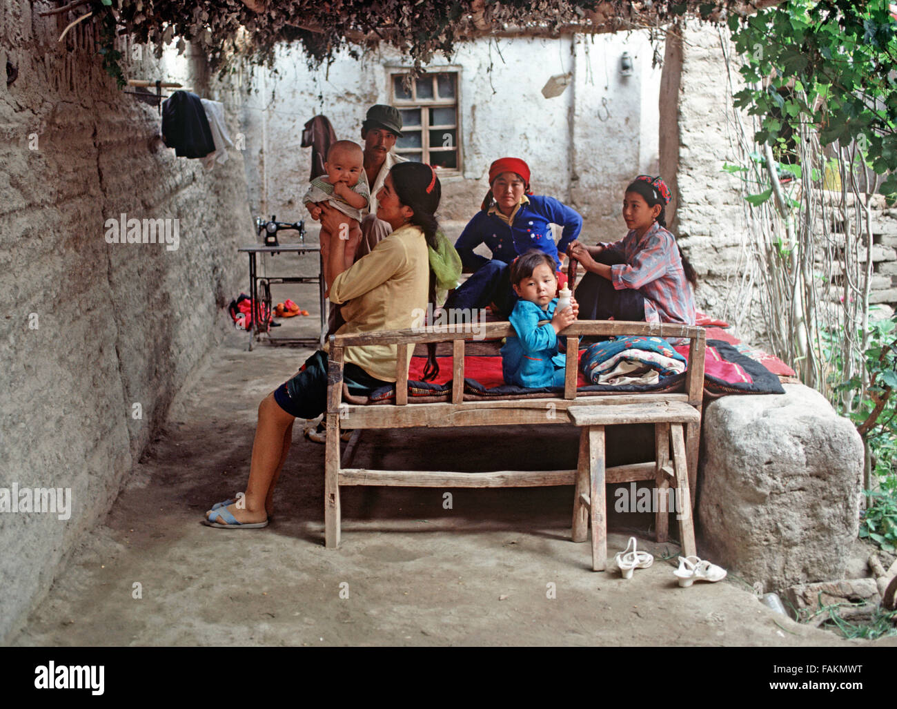 Uyghur family under shade, Turpan, Xinjiang Province, China Stock Photo