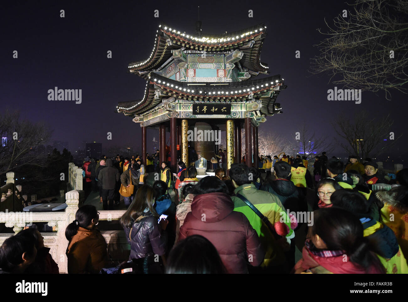 Nanjing, China's Jiangsu Province. 31st Dec, 2015. People queue to strike a huge bell to greet the New Year of 2016 at the Xuanzang Temple in Nanjing, capital of east China's Jiangsu Province, Dec. 31, 2015. Credit:  Sun Can/Xinhua/Alamy Live News Stock Photo
