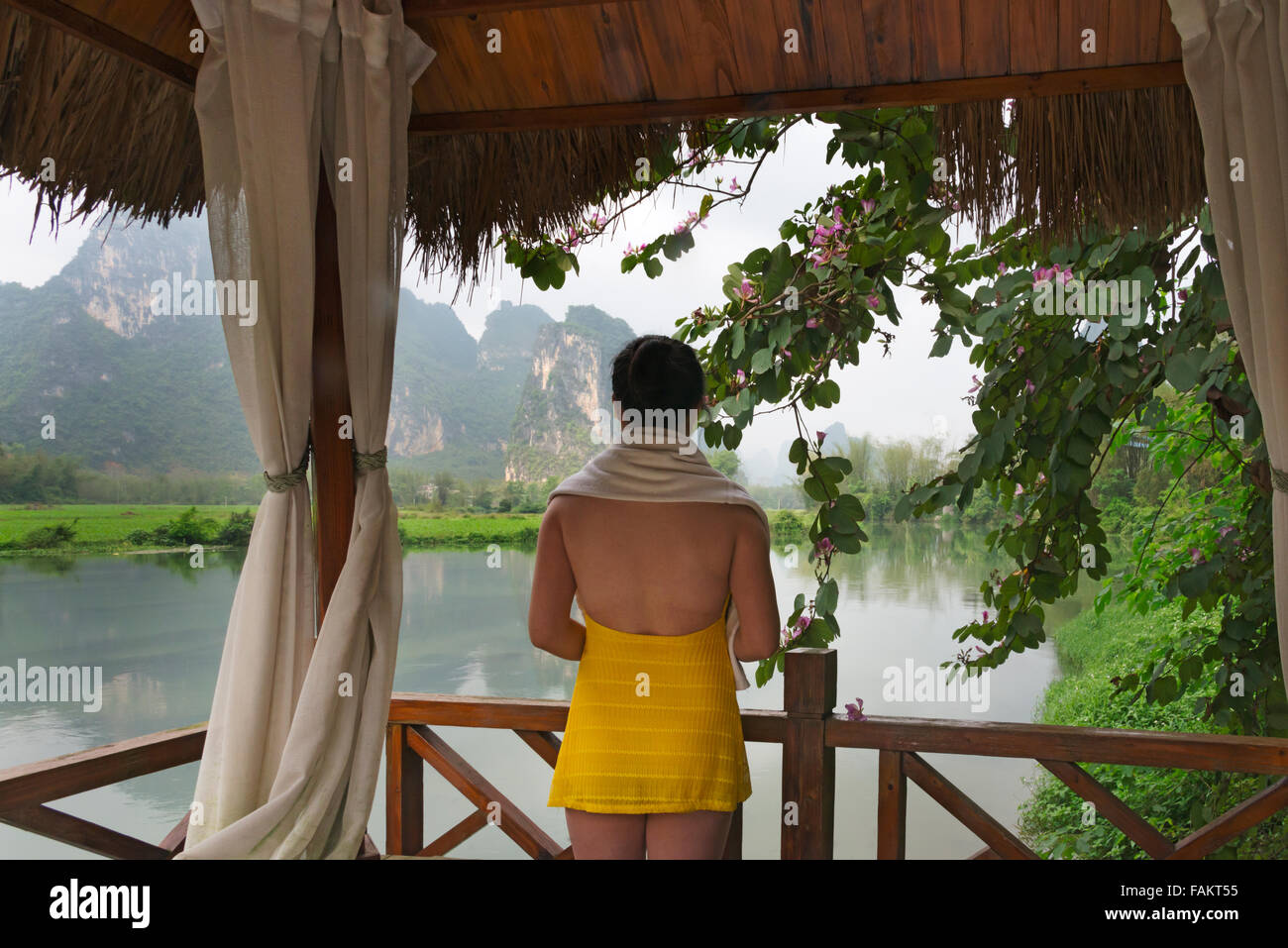 Tourists in spa balcony watching karst hills on Mingshi River, Guangxi Province, China Stock Photo