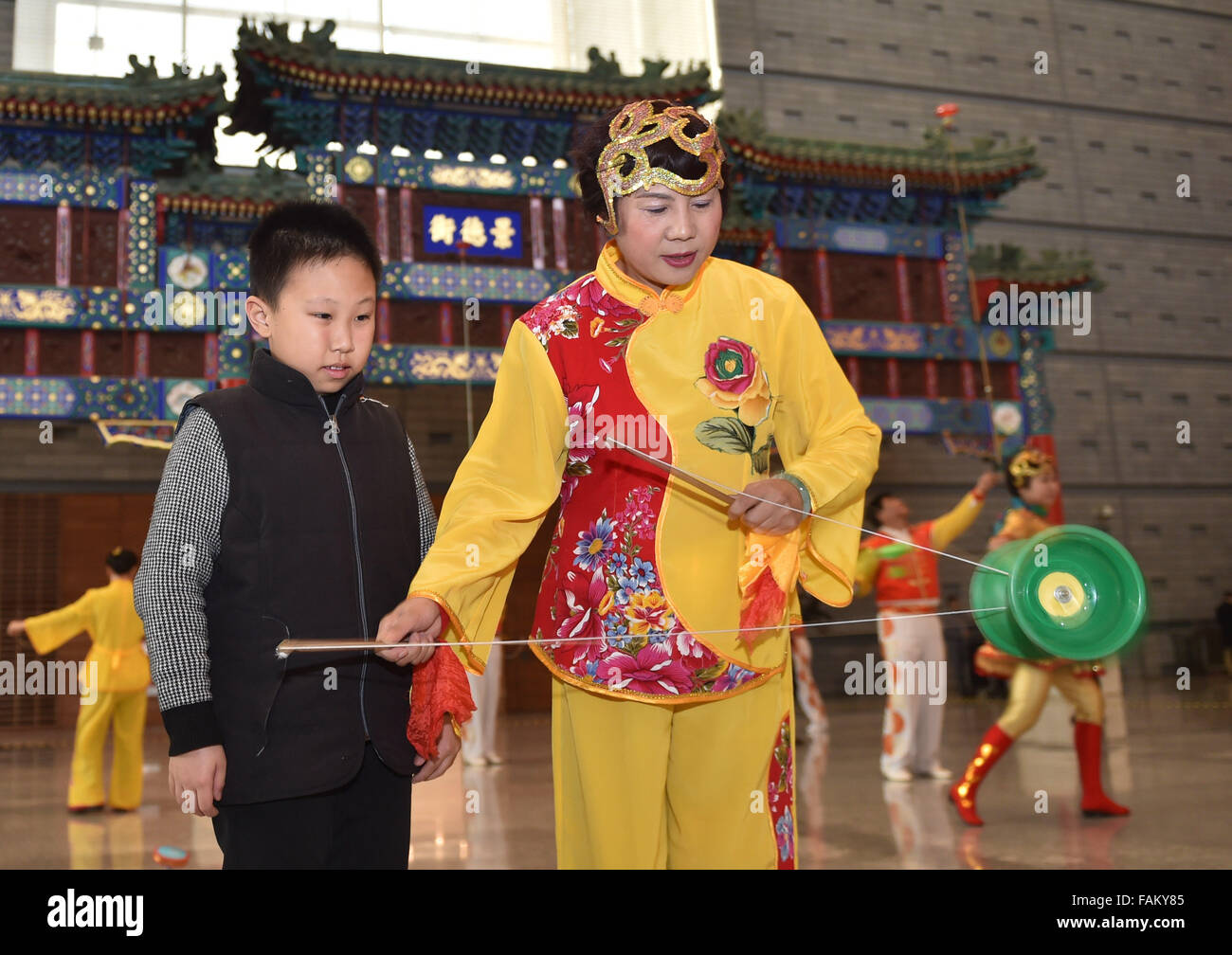 Beijing, China. 1st Jan, 2016. A folk artist presents Kongzhu, a ...
