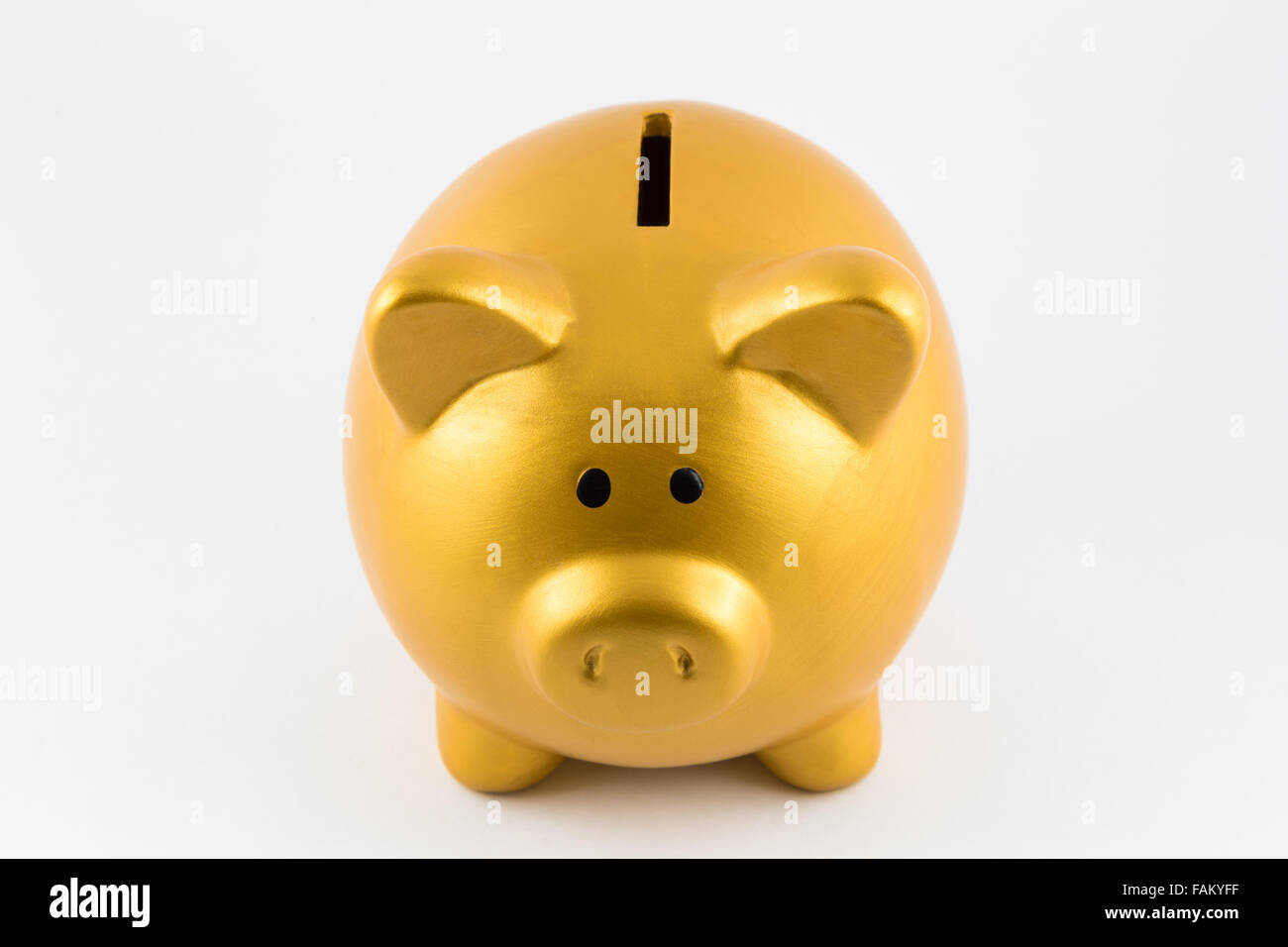 Piggy bank in gold color on isolated background Stock Photo - Alamy