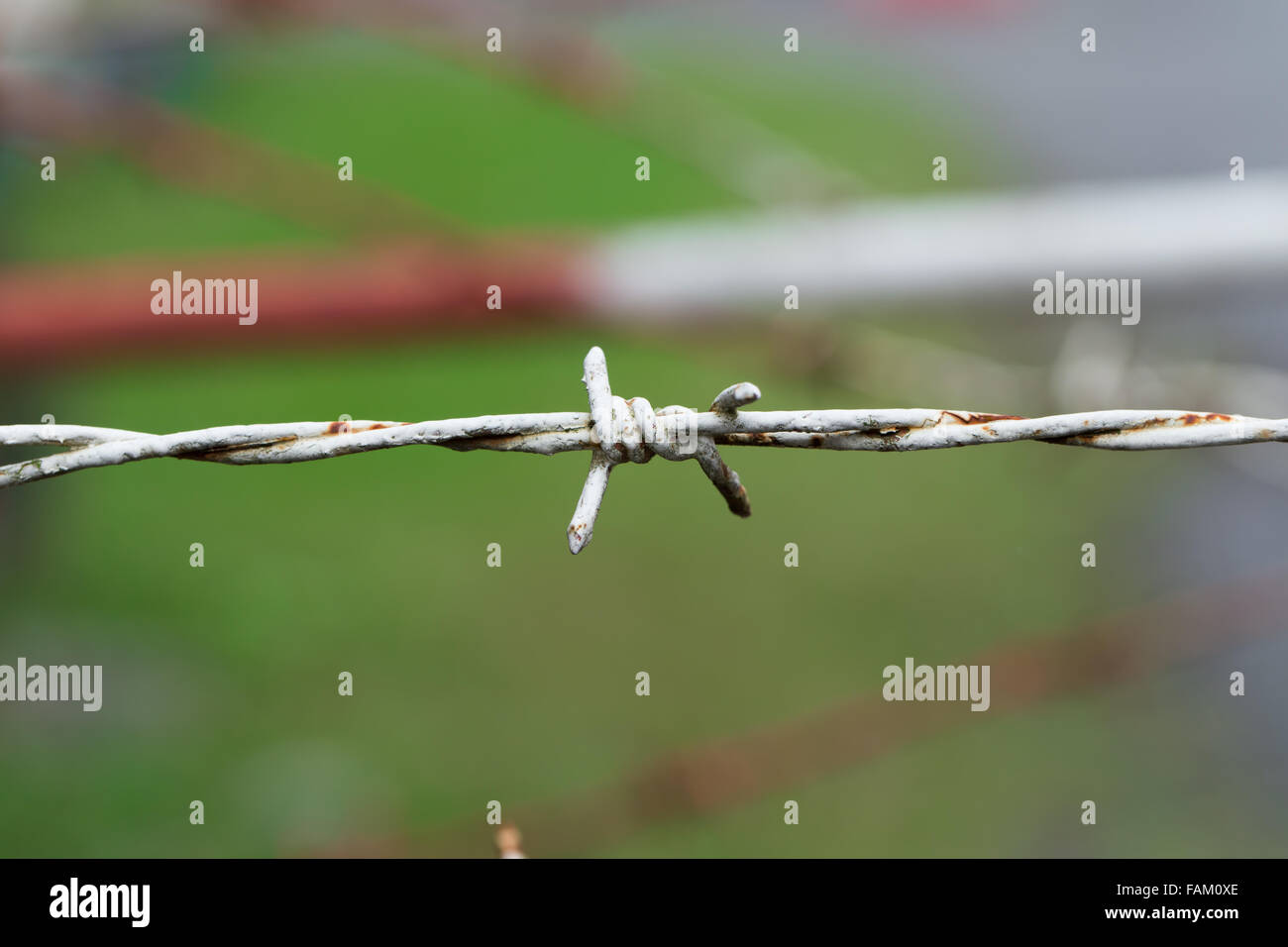 Fence made from barbed wire with rust of restricted area Stock Photo