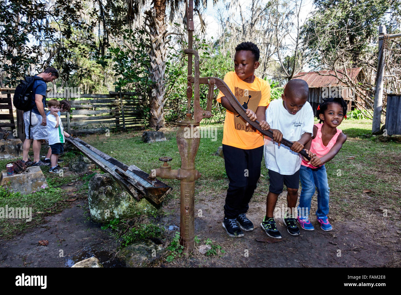 African kid with water pump hi-res stock photography and images - Alamy