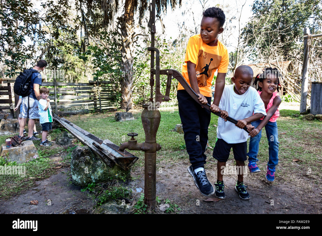 African kid with water pump hi-res stock photography and images - Alamy