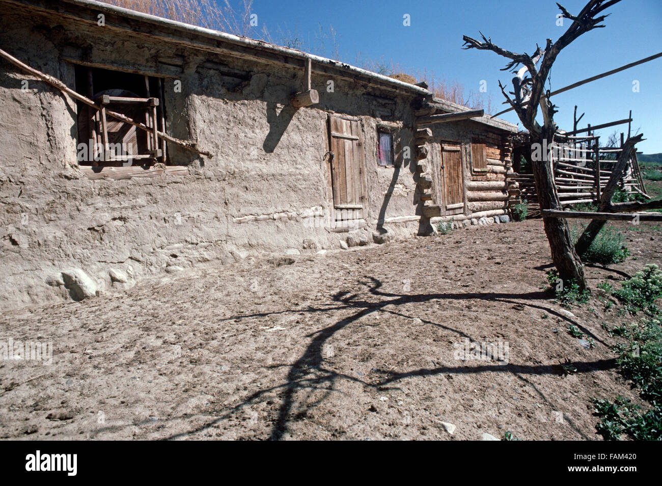 Kazakh farmhouse built out wood and mud in hills North of Urumqi, Xinjiang Province, China Stock Photo