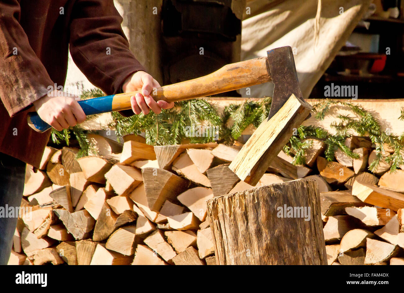 Man making firewood with axe stock photo alamy