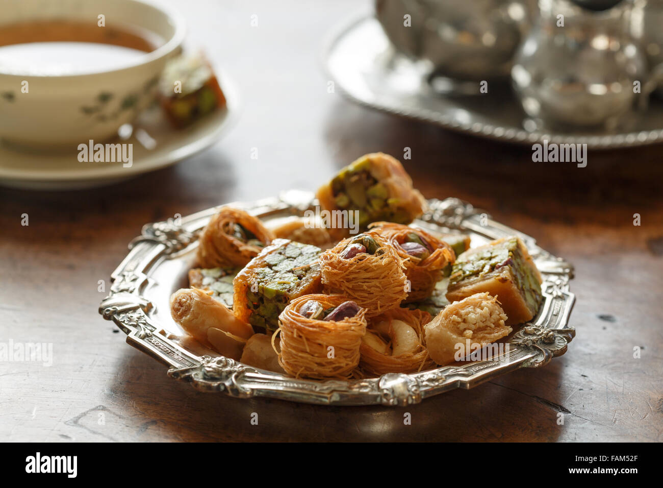 Syrian pastry with pistachios and nuts and a cup of tea Stock Photo Alamy