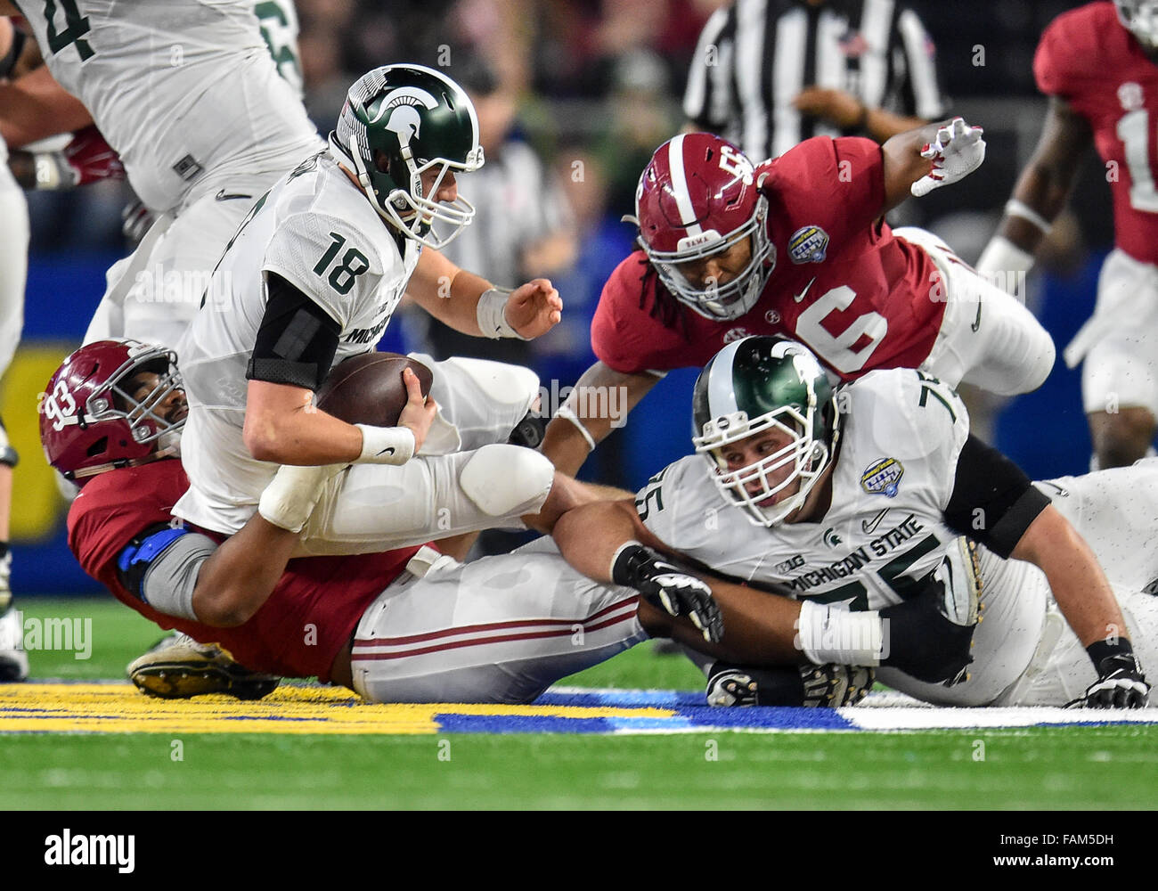 Arlington, Texas. 31st Dec, 2015. Michigan State Spartans quarterback Connor Cook (18) looks down field as Alabama Crimson Tide defensive lineman Jonathan Allen (93) rushes and gets a sack during the 2015 Goodyear Cotton Bowl game between the Michigan State Spartans and Alabama Crimson Tide at the AT&T Stadium in Arlington Texas.Alabama wins 38-0. Credit:  Manny Flores/Cal Sport Media/Alamy Live News Stock Photo