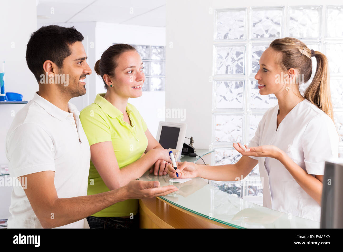 Positive young family in the waiting room of the clinic family planning Stock Photo
