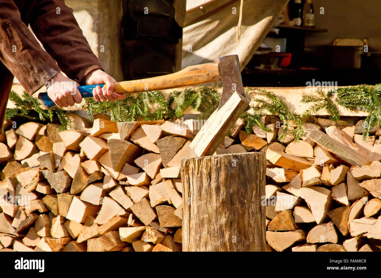 Man making firewood with axe stock photo alamy