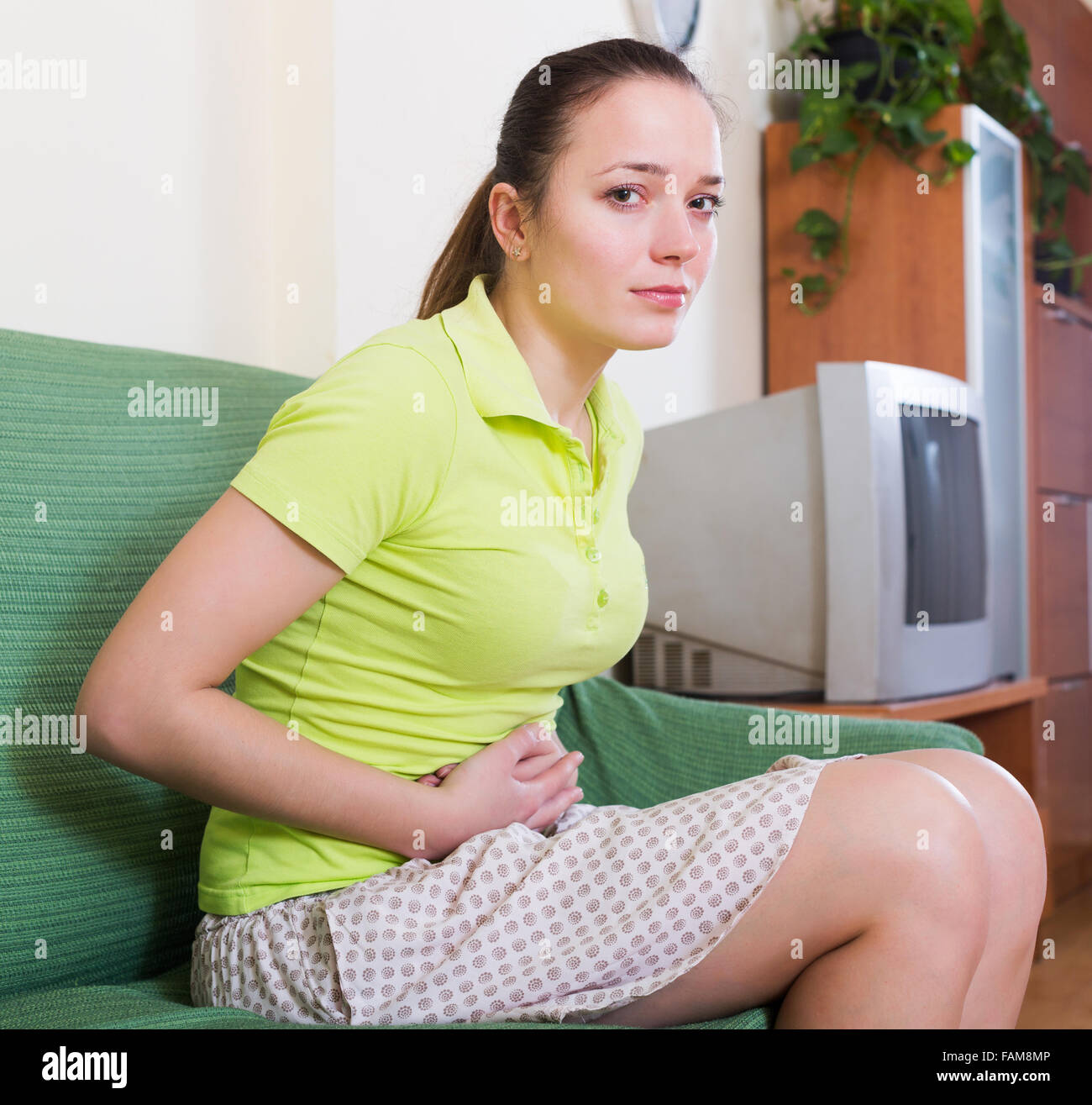 Portrait of upset girl having stomach aches at home Stock Photo Alamy