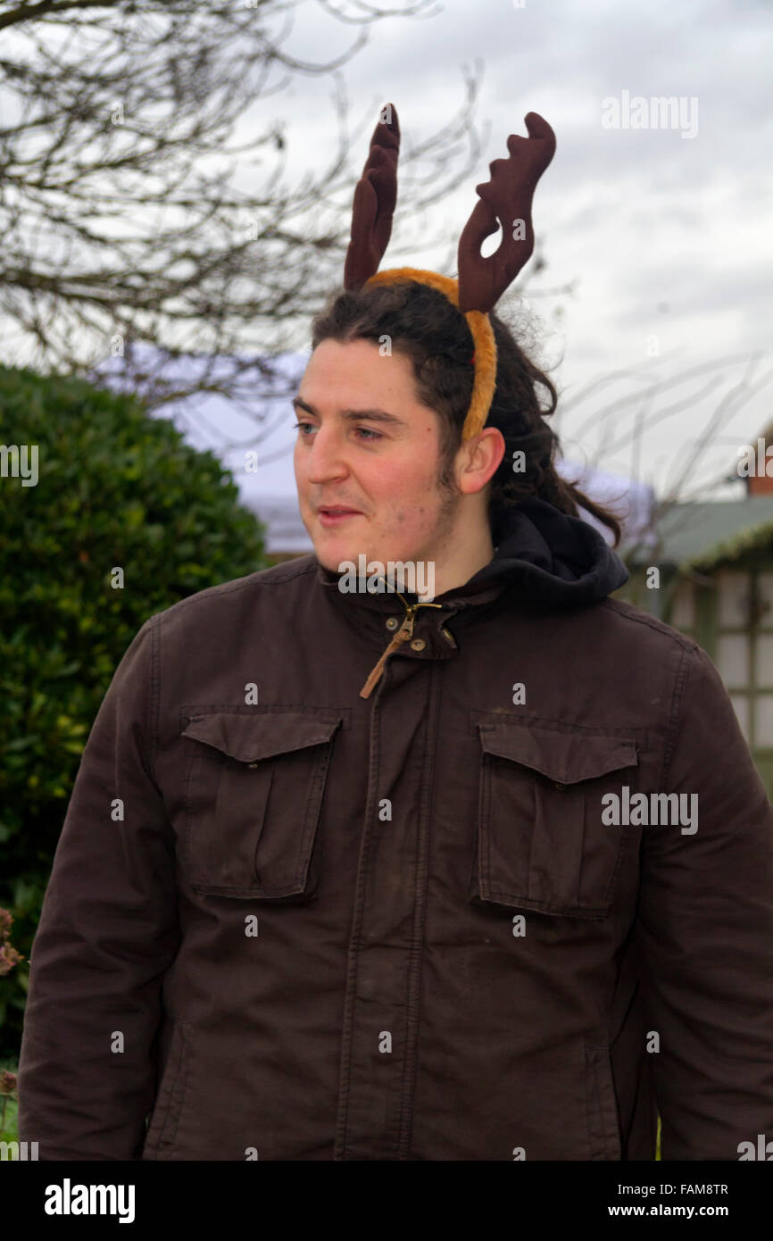 Man with dreadlocks wearing a decorative Christmas reindeer antlers head band Stock Photo