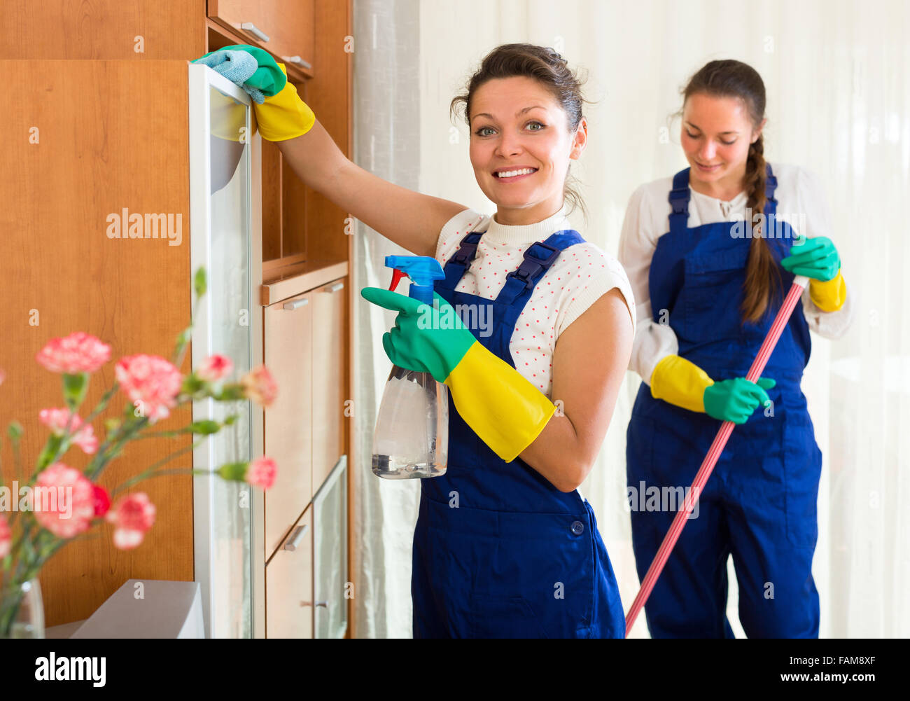 Professional cleaners team cleaning in the house with rags and mop and