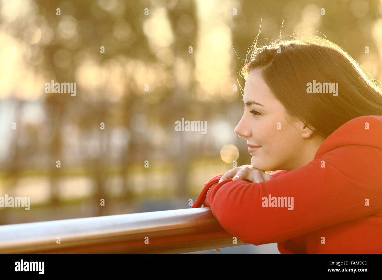 Pensive relaxed girl thinking in winter looking forward at sunset Stock Photo