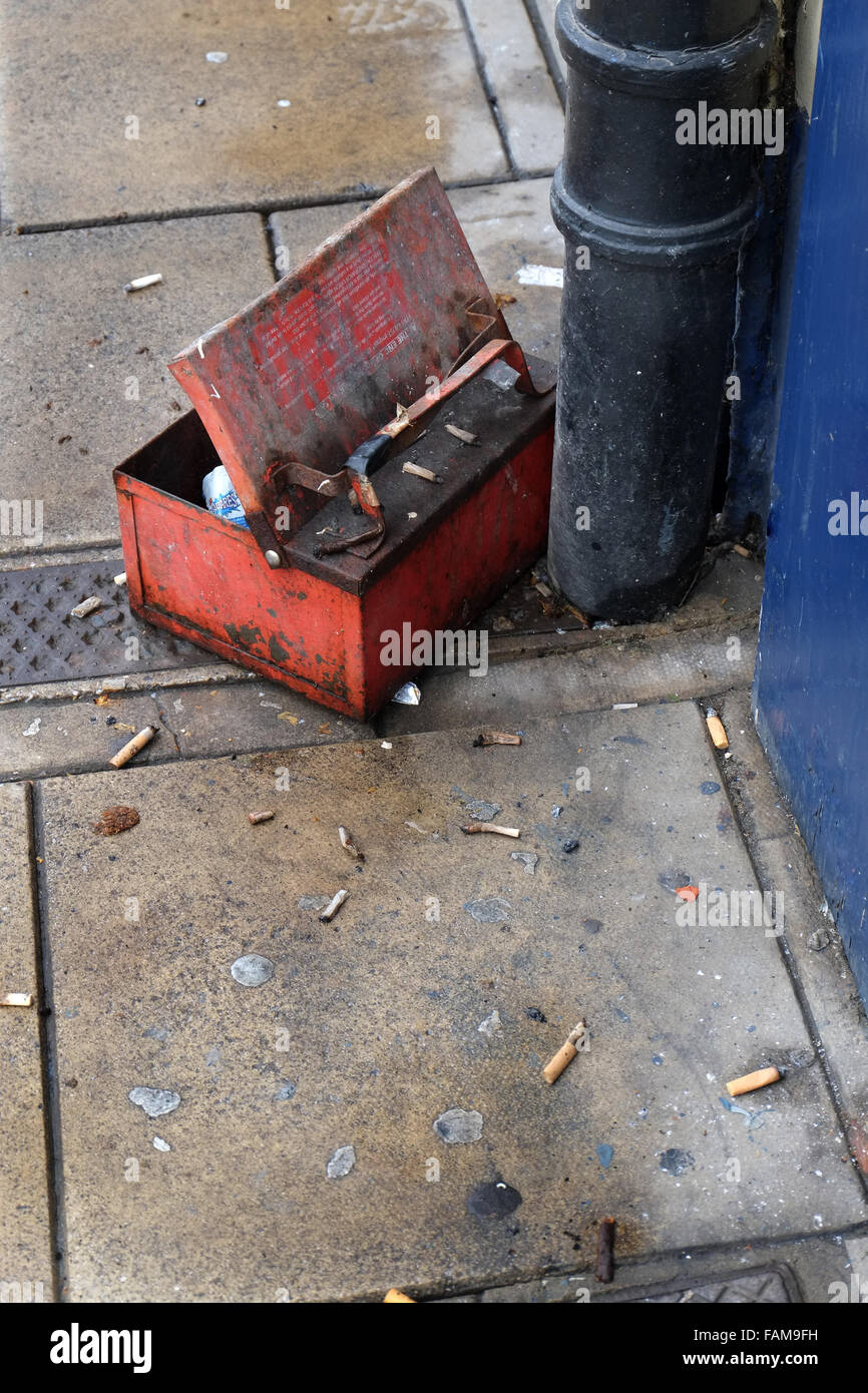 Old steel box used as waste bin for cigarette ends. Stock Photo